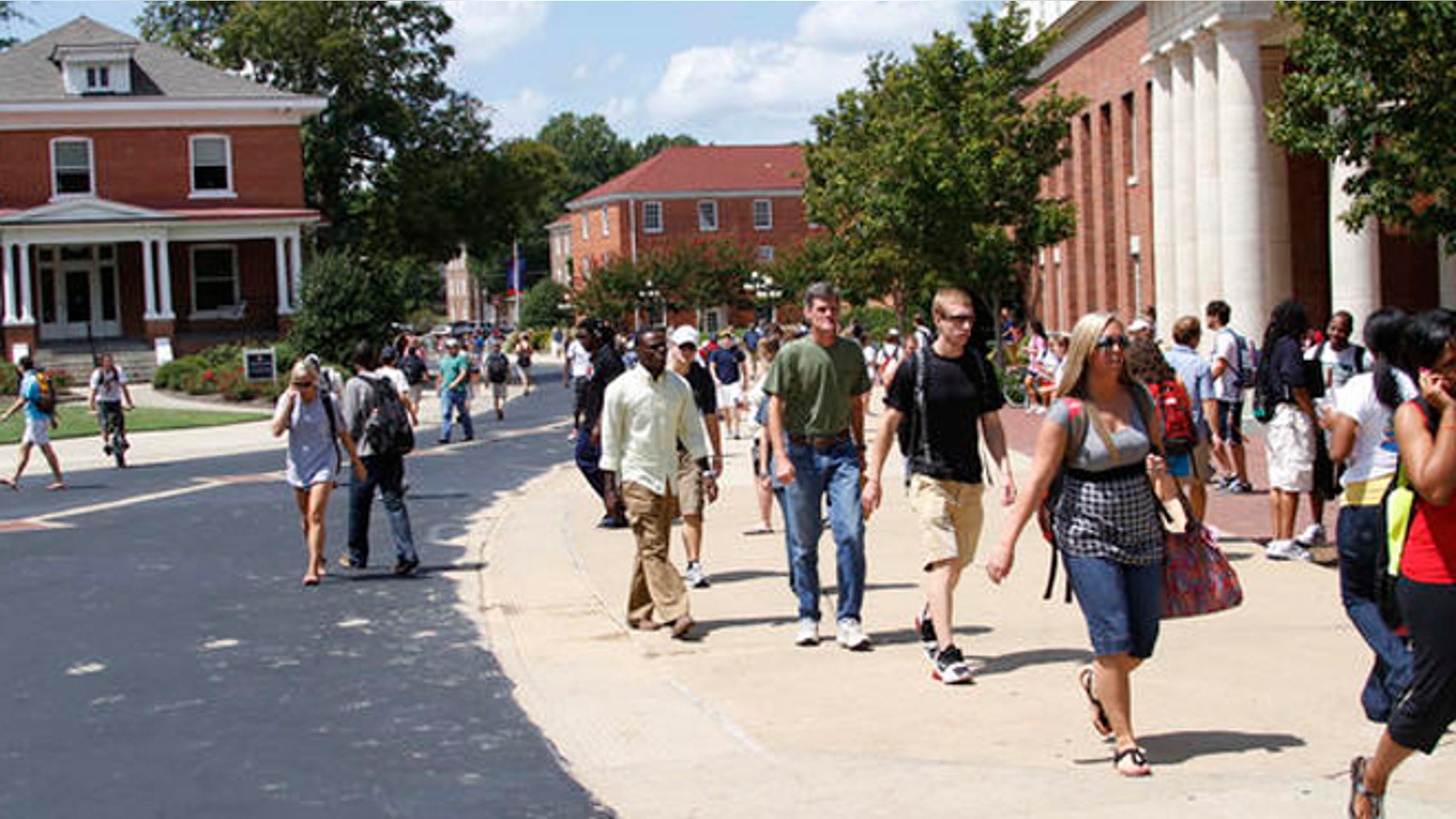 Students rush to class at the University of Mississippi, Sept. 1, 2010, in Oxford, Miss. Fiscal cuts from state funding are expected to affect all of the state's eight public colleges and may force faculty and staff layoffs, program eliminations and cuts in classes and services offered to students as well as raise various fees at the schools while they try to lessen the loss of funds. (AP Photo/Rogelio V. Solis)
