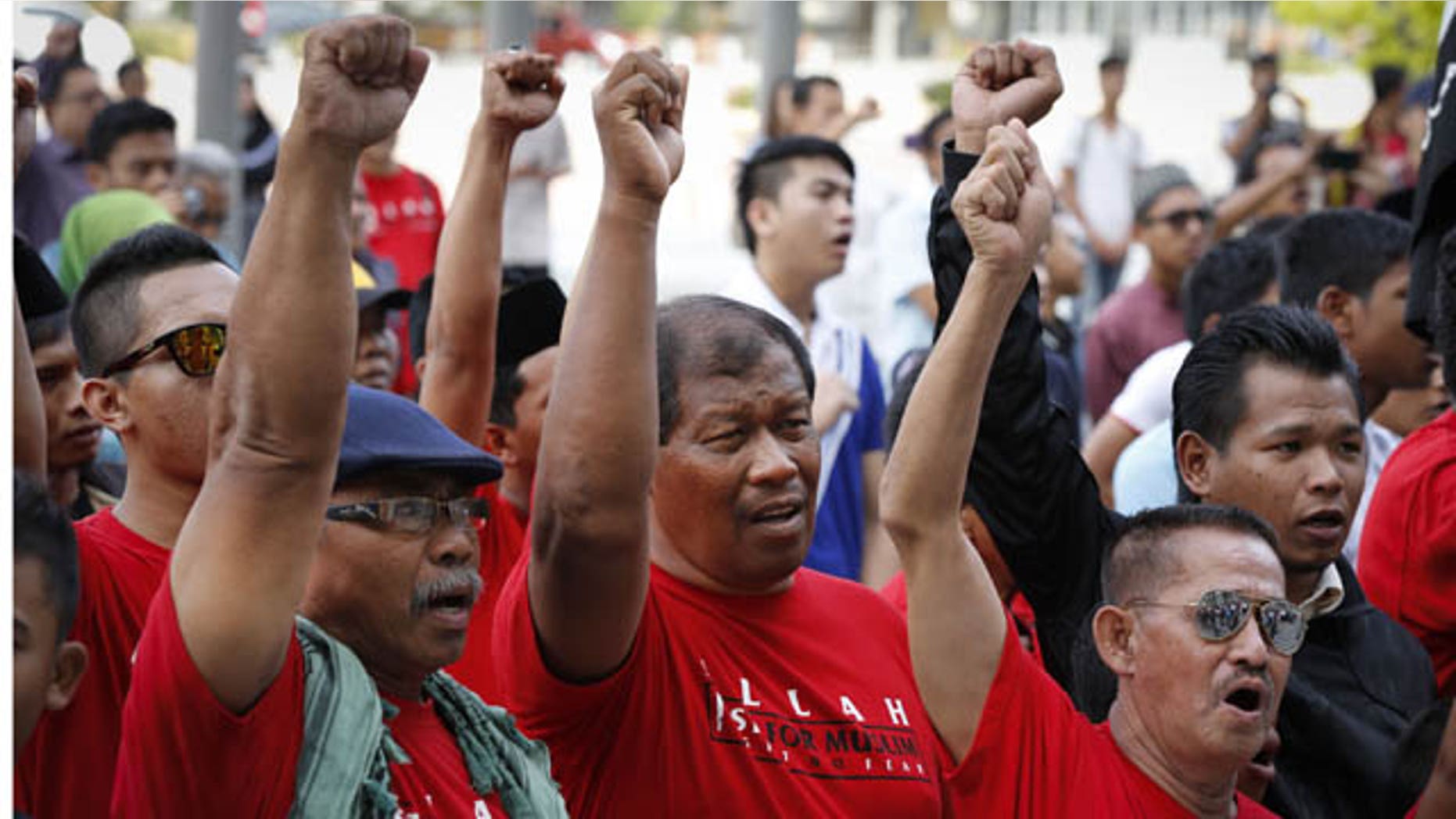 October 14, 2013: Muslim demonstrators chant slogans outside the Court of Appeal in Putrajaya, outside Kuala Lumpur, Malaysia, Monday. (AP Photo)