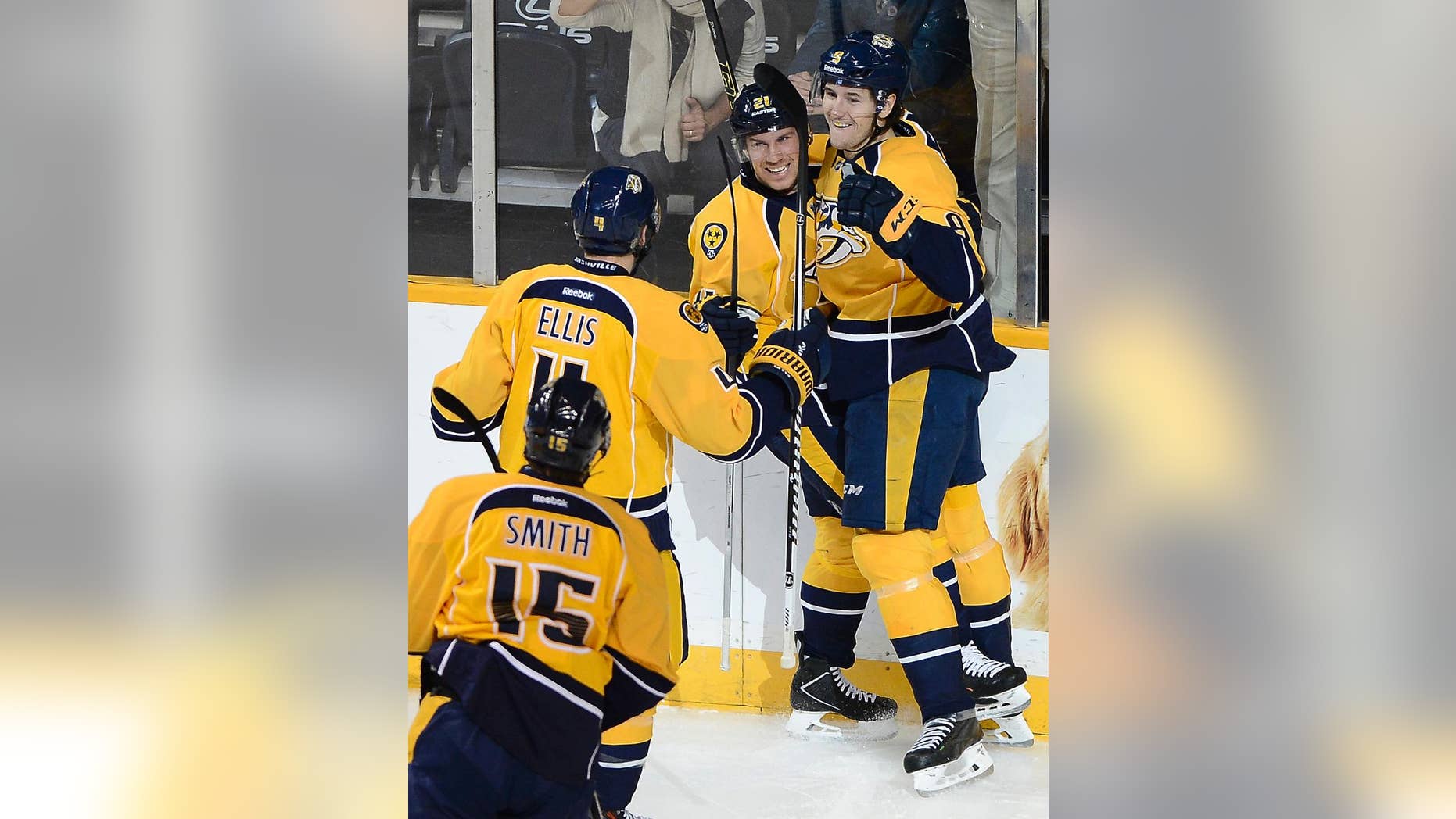 Nashville Predators center Filip Forsberg (9) celebrates with center Derek Roy (21), defenseman Ryan Ellis (4) and center Craig Smith (15) after Forsberg scored against the Calgary Flames in the first period of an NHL hockey game Tuesday, Oct. 14, 2014, in Nashville, Tenn. (AP Photo/Mark Zaleski)