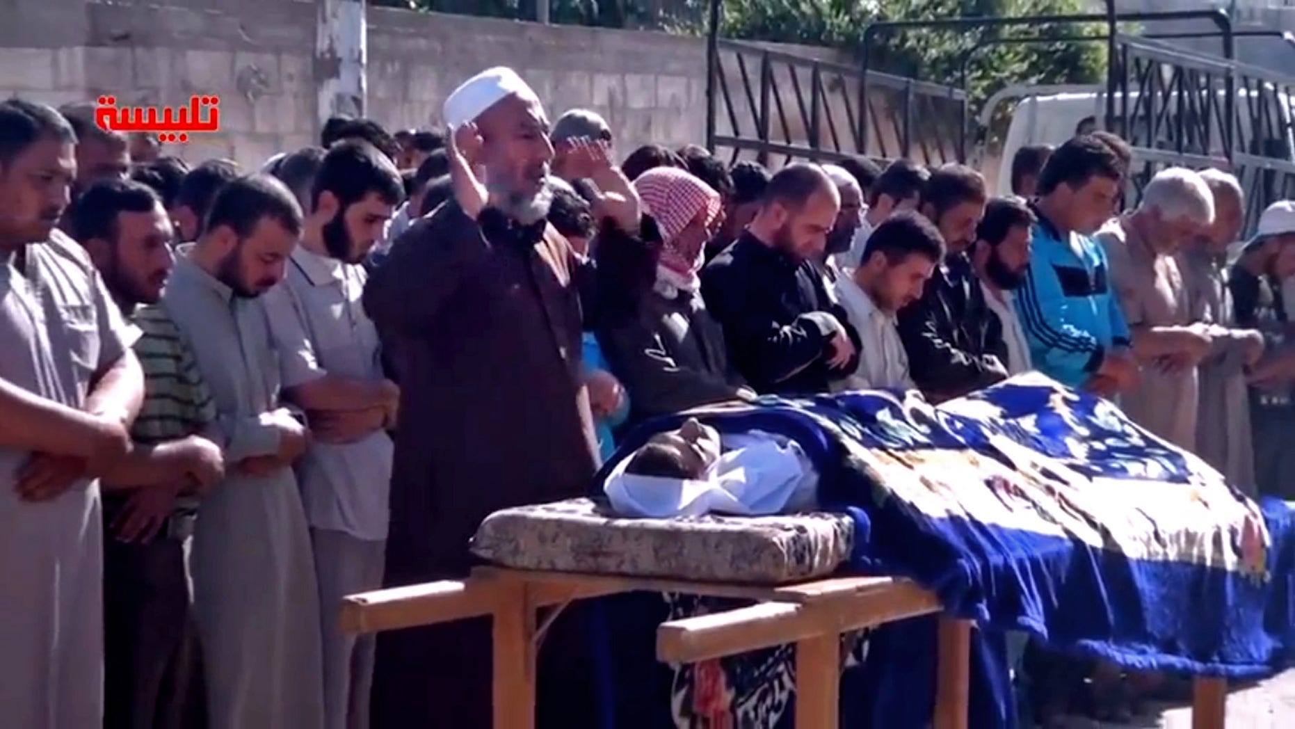 In this image taken from video obtained from the Shaam News Network, which has been authenticated based on its contents and other AP reporting, Syrians participate in the funeral prayer for Youssef Ghazi al-Sarmani who was killed in fighting between rebel and government forces, Monday, May 27, 2013. Logo in red reads, "Talbiseh". (AP Photo/Shaam News Network via AP video)