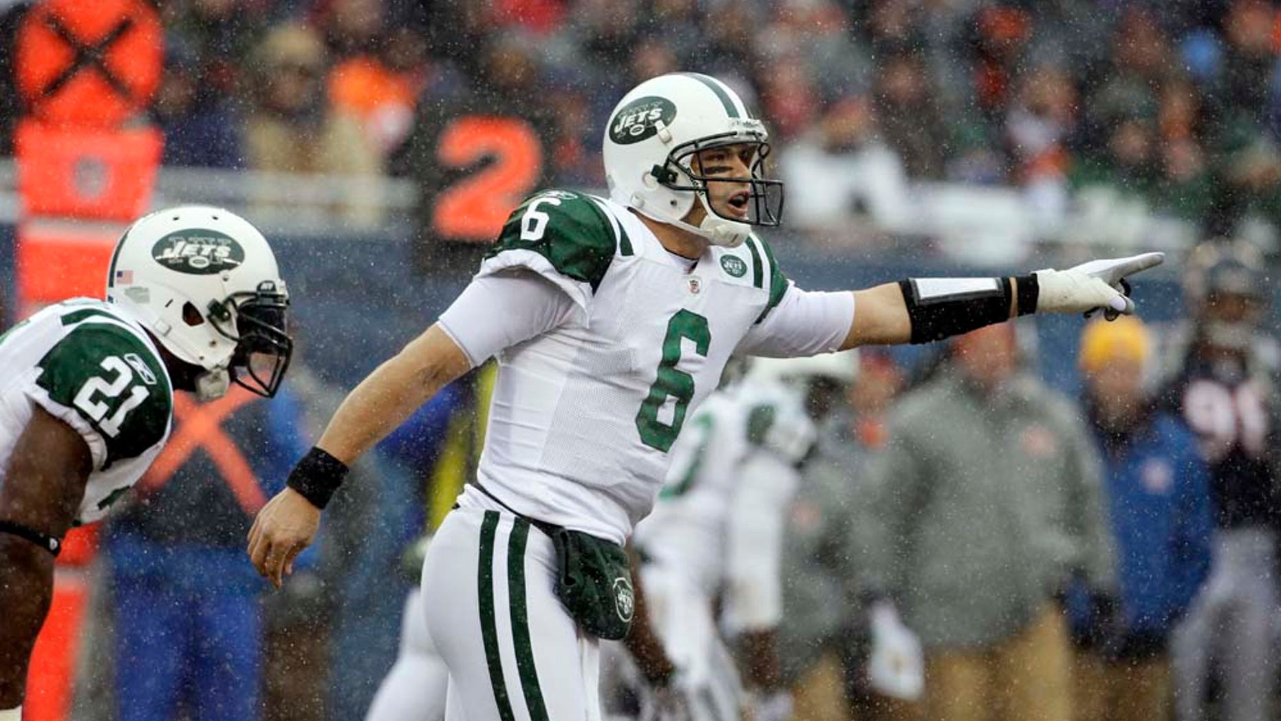 New York Jets quarterback Mark Sanchez (6) calls a play against the Chicago Bears in the first half an NFL football game in Chicago, Sunday, Dec. 26, 2010. At left is Jets running back LaDainian Tomlinson (21). (AP Photo/Darron Cummings)