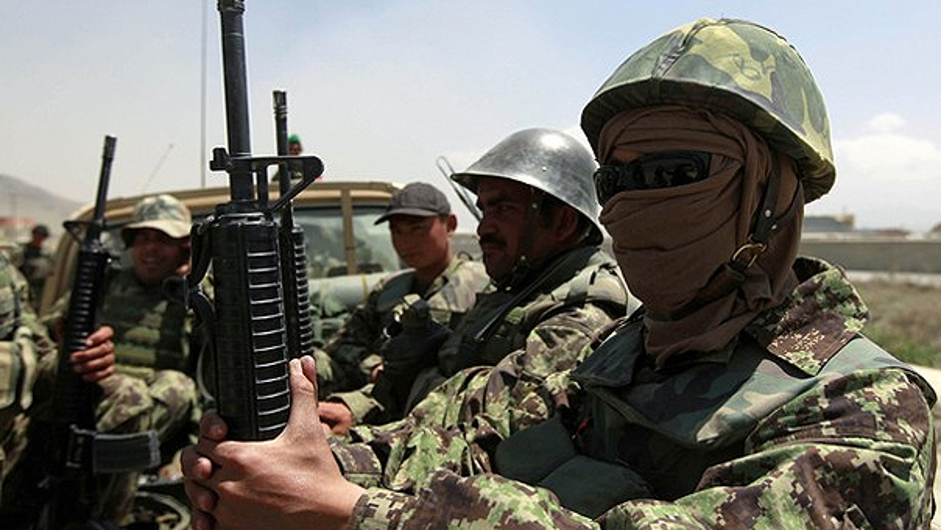 April 27: Afghan National Army (ANA) soldiers arrive at the gate of the Afghan air force compound in Kabul.