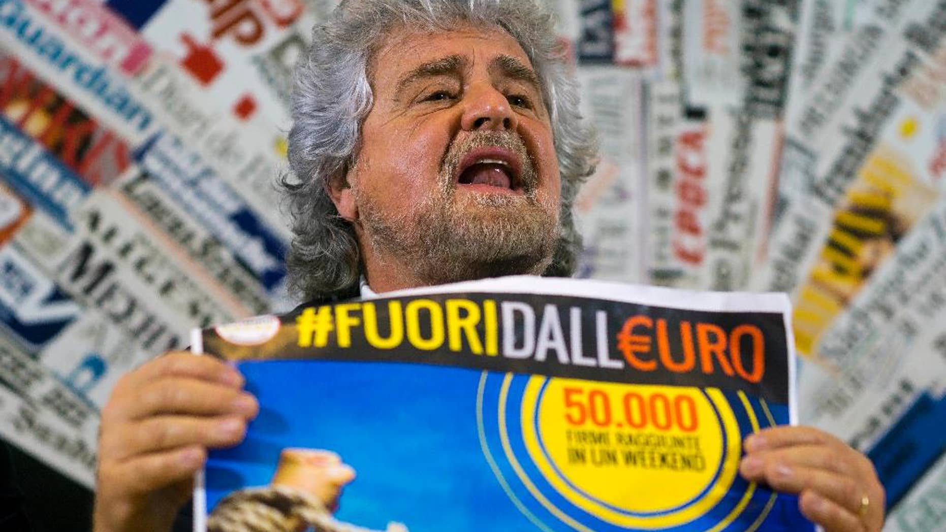 FILE - In this Dec. 18, 2014 file photo, 5-Star Movement leader Beppe Grillo shows a poster in Italian reading "Out of the euro, 50,000 signatures already collected in a weekend", as he speaks during a press conference at the Foreign Press Club in Rome. Italy's populist 5-Star Movement on Monday, Jan. 9, 2017 voted to join the liberal ALDE group in the European Parliament in an about-face power play that has sent shockwaves through the European Union legislature. (AP Photo/Domenico Stinellis, File)