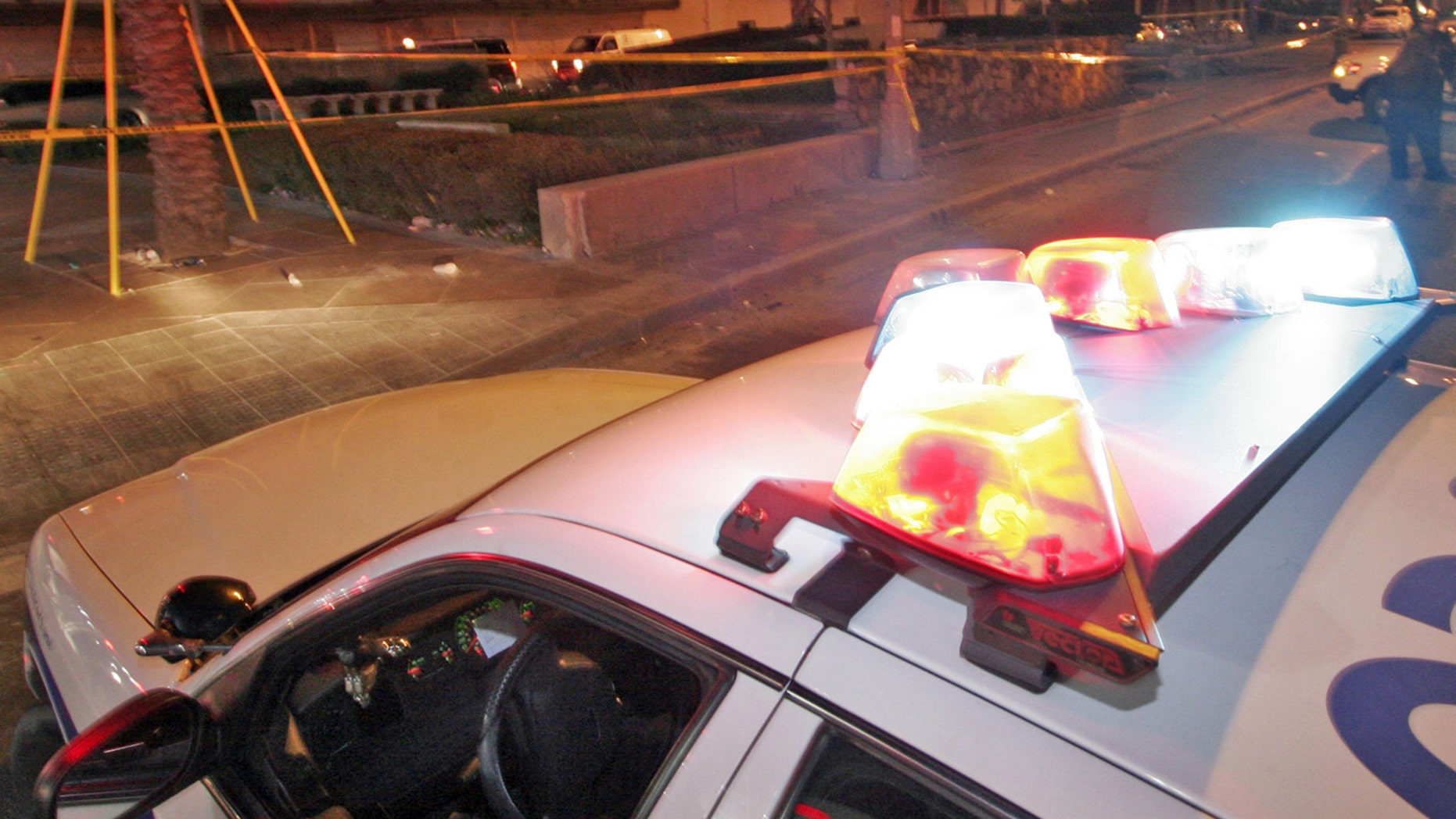 New Orleans Police investigate the scene where two people were shot as a parade was ending a few blocks away on Canal Street in New Orleans Sunday, Feb. 18, 2007.(AP Photo/Alex Brandon)