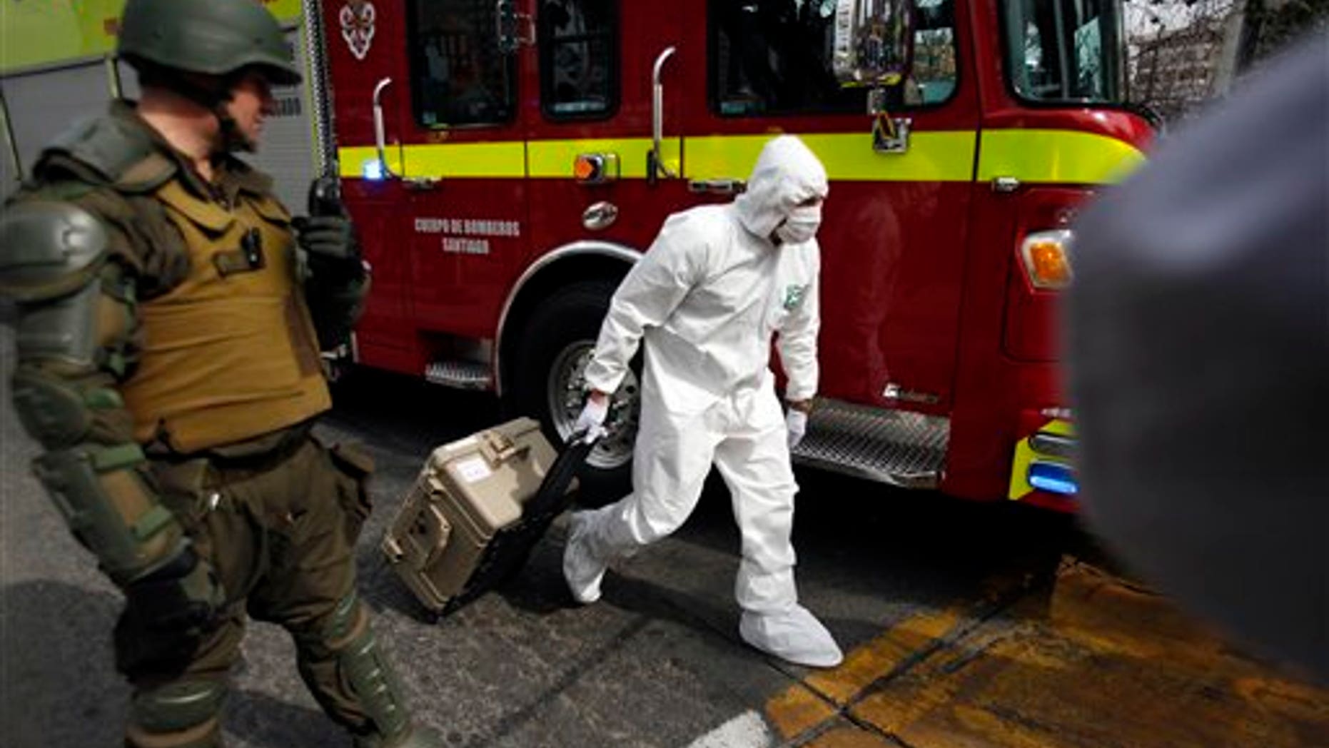A police forensic expert arrives to the blast site at a subway station in Santiago, Chile, Monday, Sept. 8, 2014.