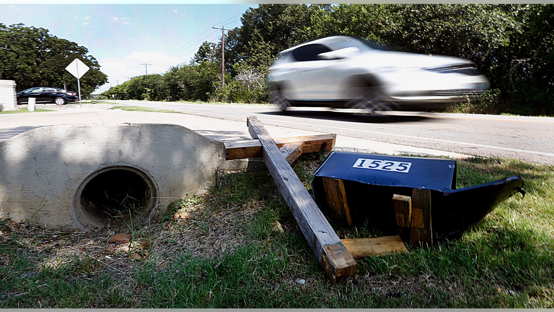 File - In this June 16, 2013 file photo, cars drive past the scene of a fatal wreck. A North Texas juvenile court judge has sentenced 16-year-old boy Ethan Couch to probation for the crash that killed four people. Judge Jean Boyd issued the original sentence, but has not ruled on a prosecution request to give Couch jail time on charges related to the two people who were injured. A Wednesday, Feb. 5, 2014 hearing is scheduled in the case. (AP Photo/The Fort Worth Star-Telegram, Ben Noey Jr., File) MAGS OUT; (FORT WORTH WEEKLY, 360 WEST); INTERNET OUT