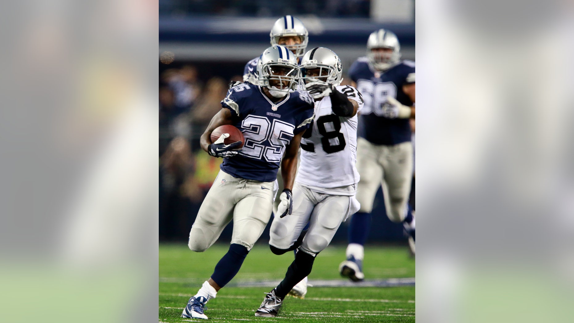 Dallas Cowboys running back Lance Dunbar (25) gets a first down as Oakland Raiders cornerback Phillip Adams (28) trails during the second half of an NFL football game Thursday, Nov. 28, 2013, in Arlington, Texas. (AP Photo/The Waco Tribune-Herald, Jose Yau)