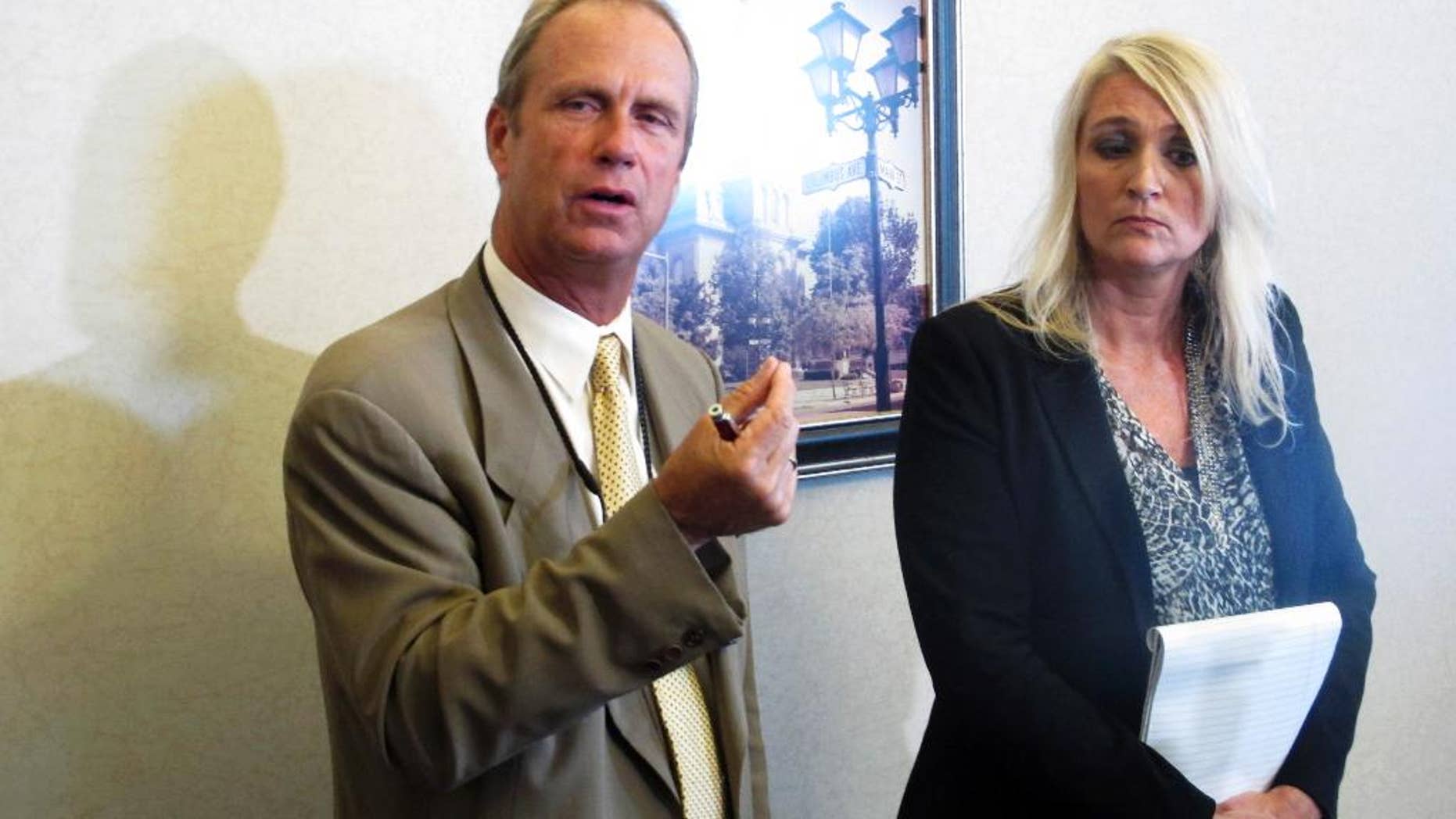 Logan County Prosecutor William Goslee, left, talks about a woman accused of killing her three sons over a 13-month span, alongside Melanie Engle, executive director of Logan County Children's Services, whose agency fought to keep a son who died from being returned home, on Wednesday, Aug. 19, 2015, in Bellefontaine, Ohio. Goslee said the system couldn't have foreseen such erratic behavior by the suspect. (AP Photo/Andrew Welsh-Huggins)