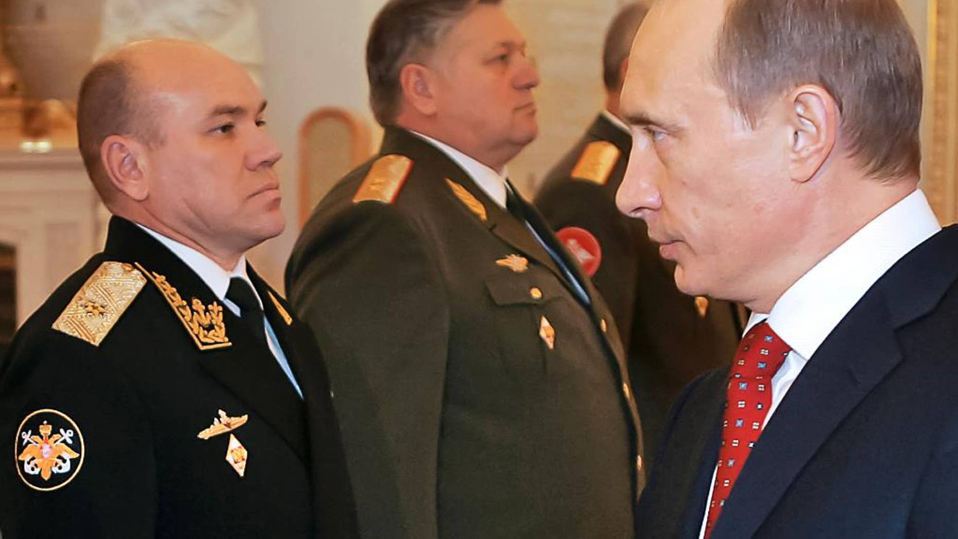 FILE In this file photo taken on Thursday, Feb. 30, 2016, Russian President Vladimir Putin, right, looks at Rear Adm. Viktor Kravchuk, left, during his meeting with a group of top military officers in the Moscow Kremlin, Russia. Russia's defense minister has fired the commander of the Baltic Fleet Viktor Kravchuk, and his top officers following a sweeping inspection. (Vladimir Rodinov, Sputnik, Kremlin Pool Photo via AP, file)