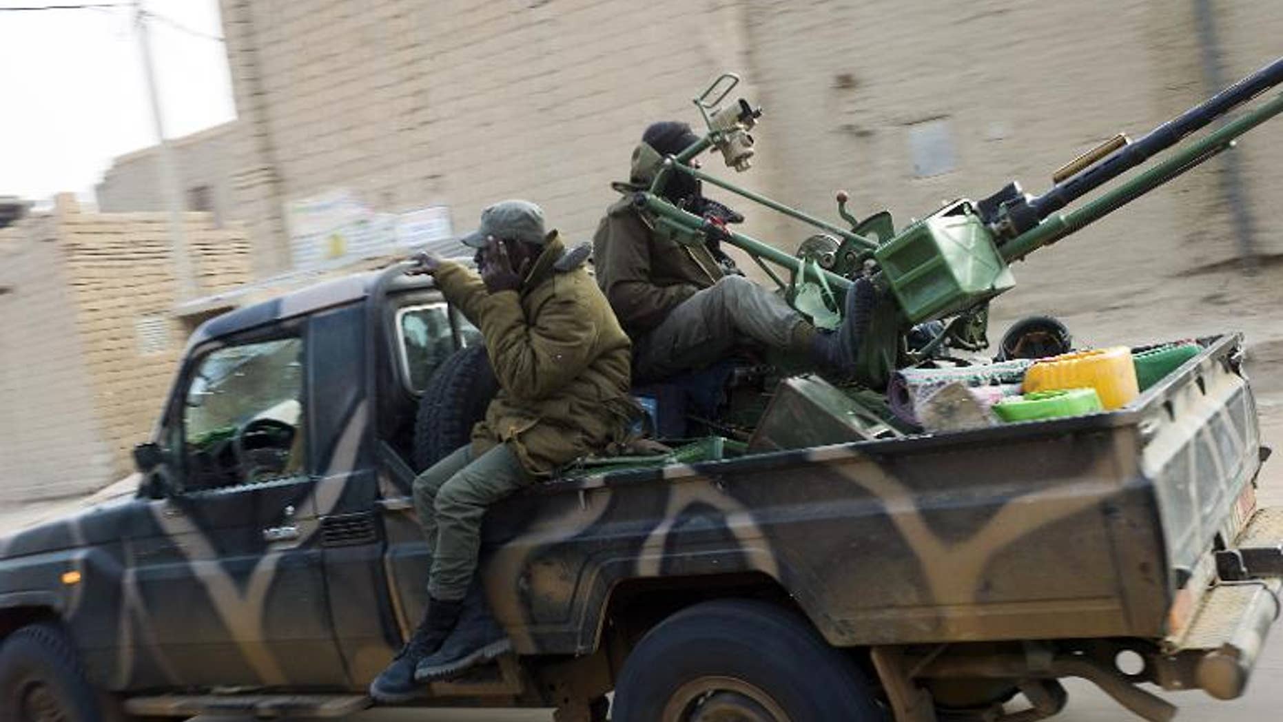 Malian soldiers patrol in the streets of Timbuktu on February 1, 2013