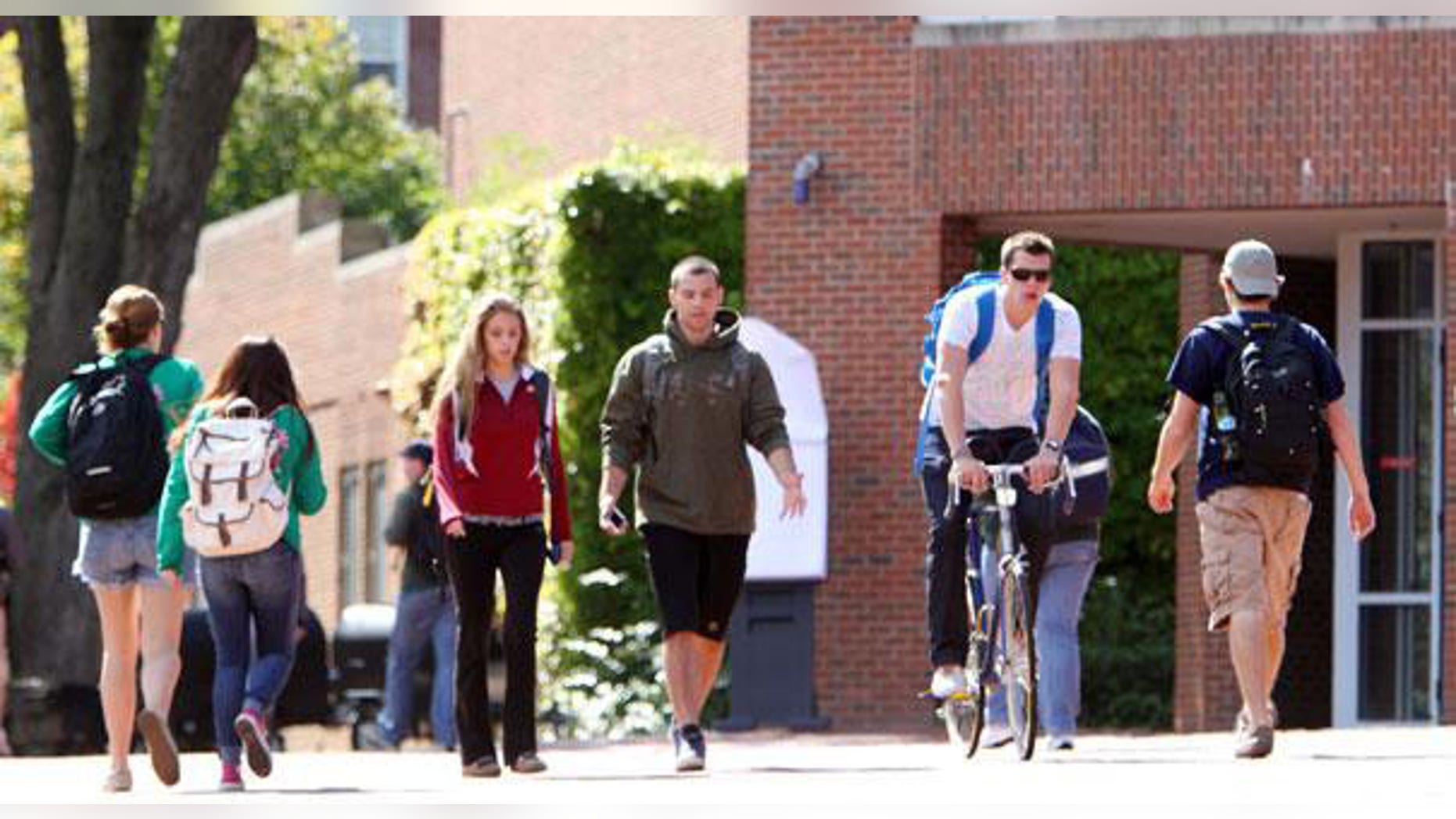 Students are pictured walking through a college campus.