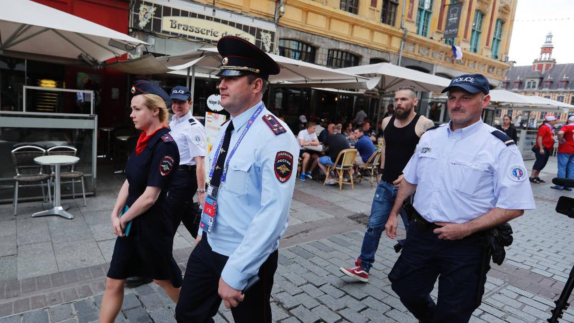 Russian police officers walk through a square in downtown Lille, Wednesday, June 15, 2016 after being called into to bolster security ahead of the Euro 2016 Group B soccer match between Russia and Slovakia at the Pierre Mauroy stadium in Villeneuve d’Ascq, near Lille. UEFA gave Russia a suspended disqualification from the tournament after violence at their previous match against England in Marseille. (AP Photo/Darko Bandic)