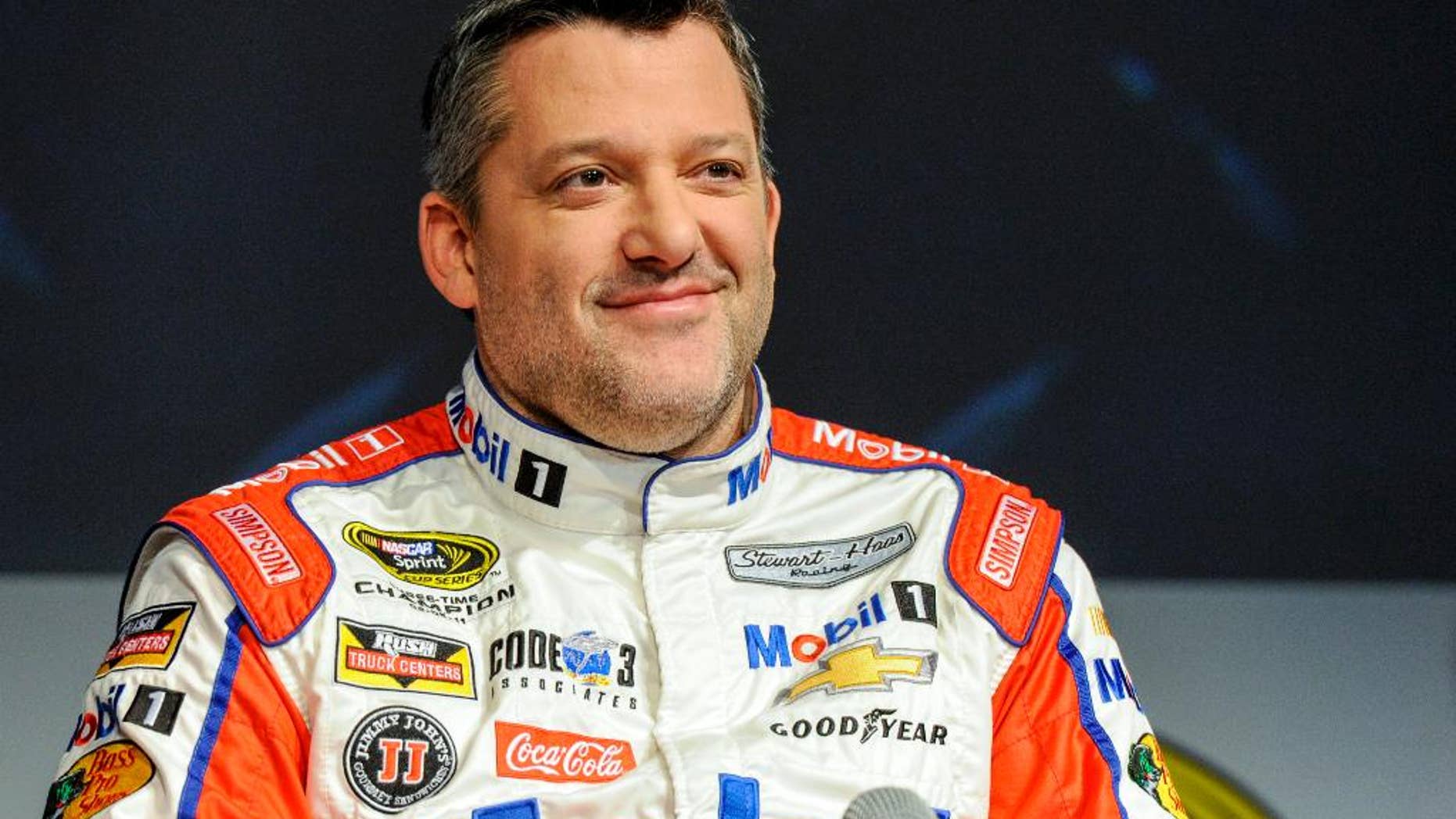 FILE - In this Thursay, Jan. 21, 2016, file photo, Stewart Haas Racing co-owner and driver Tony Stewart talks to members of the media during the NASCAR Charlotte Motor Speedway Media Tour in Charlotte, N.C. Stewart suffered his first serious hit since his return from a back injury during a three-car wreck at practice at Dover International Speedway, Friday, May 13, 2016. (AP Photo/Mike McCarn, File)