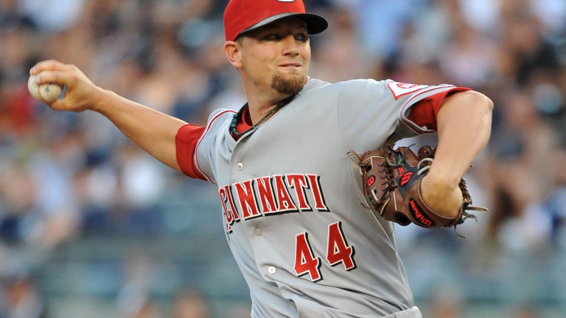 Cincinnati Reds starter Mike Leake throws against the New York Yankees in the first inning of an interleague baseball game at Yankee Stadium on Friday, July 18, 2014, in New York. (AP Photo/Kathy Kmonicek)