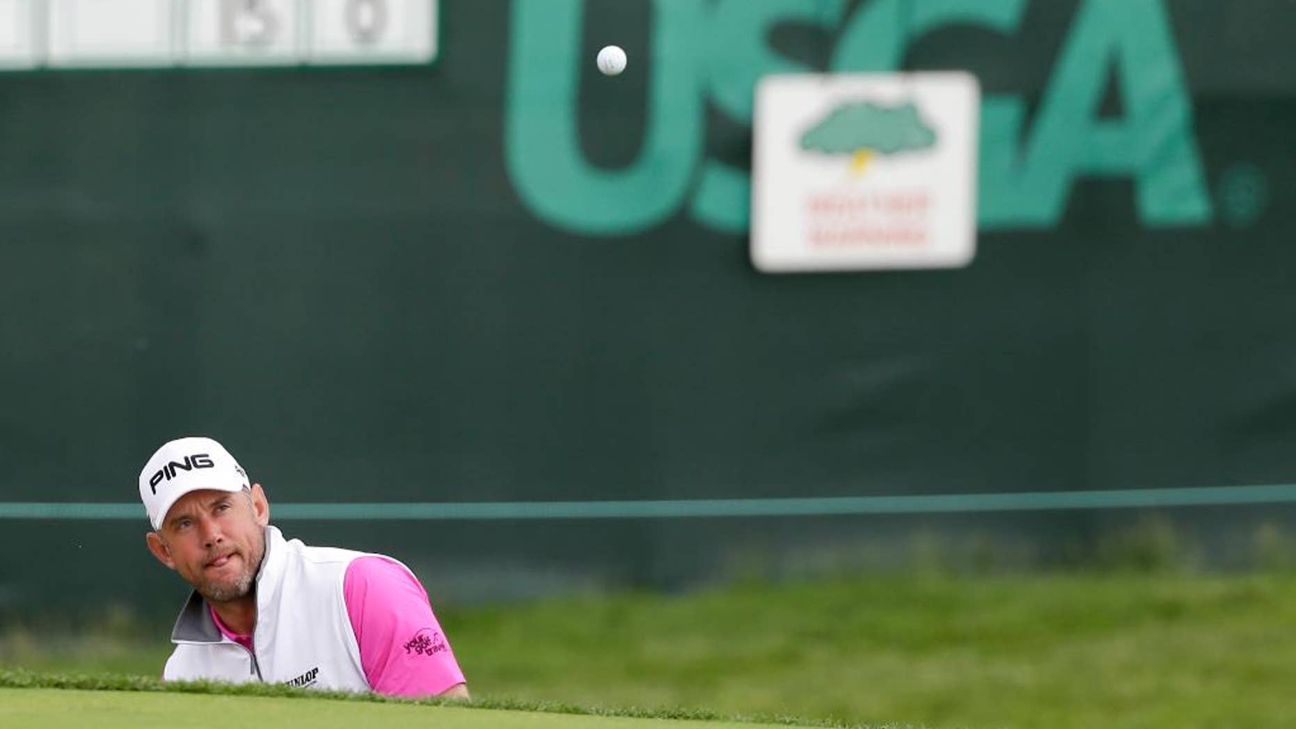Lee Westwood, of England, hits out of the bunker on the seventh hole during the rain delayed first round of the U.S. Open golf championship at Oakmont Country Club on Friday, June 17, 2016, in Oakmont, Pa. (AP Photo/Gene J. Puskar)
