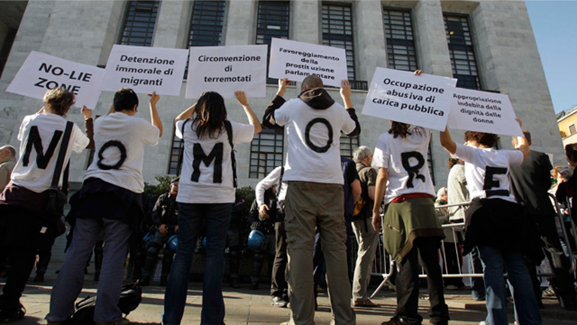 April 6: People wear t-shirts composing the sentence "No more" as they hold up placards during a protest outside the Milan court in Italy.