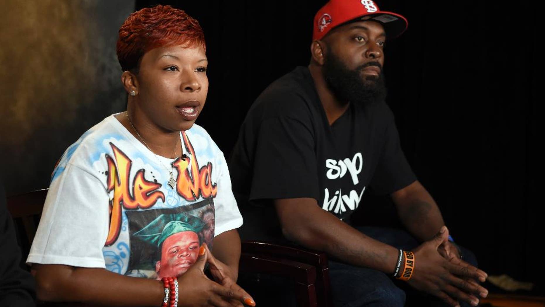FILE - In this Sept. 27, 2014 file photo, the parents of Michael Brown, Lesley McSpadden, left, and Michael Brown, Sr., right, sit for an interview with The Associated Press in Washington. Attorneys representing Ferguson, Mo., its former police chief and an ex-officer in a wrongful-death lawsuit by Brown's parents are pressing the latest quest for access to any of the late 18-year-old's juvenile records. Anthony Gray, a Brown family attorney, has said any brush by Brown with the juvenile court system is irrelevant to whether Brown's 2014 death resulted from excessive police force.(AP Photo/Susan Walsh, File)