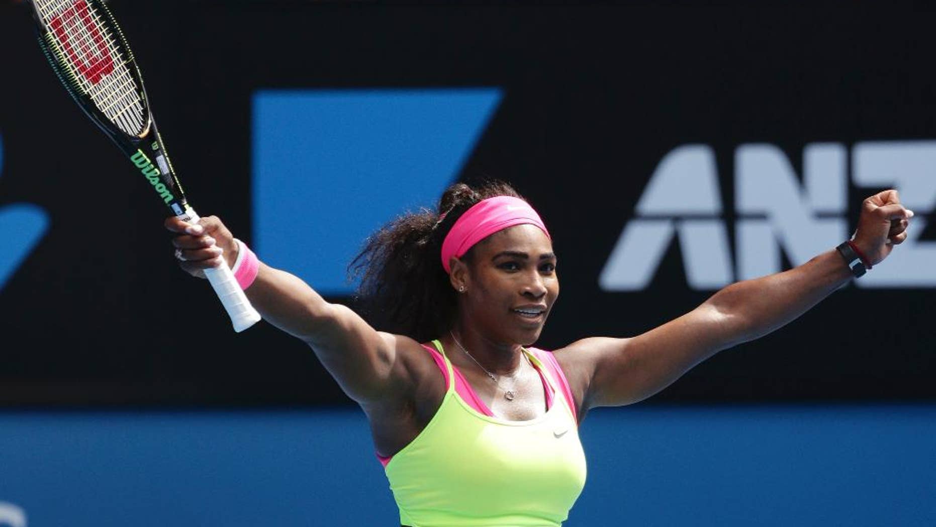 Serena Williams of the U.S. celebrates after defeating Garbine Muguruza of Spain in their fourth round match at the Australian Open tennis championship in Melbourne, Australia, Monday, Jan. 26, 2015. (AP Photo/Rob Griffith)
