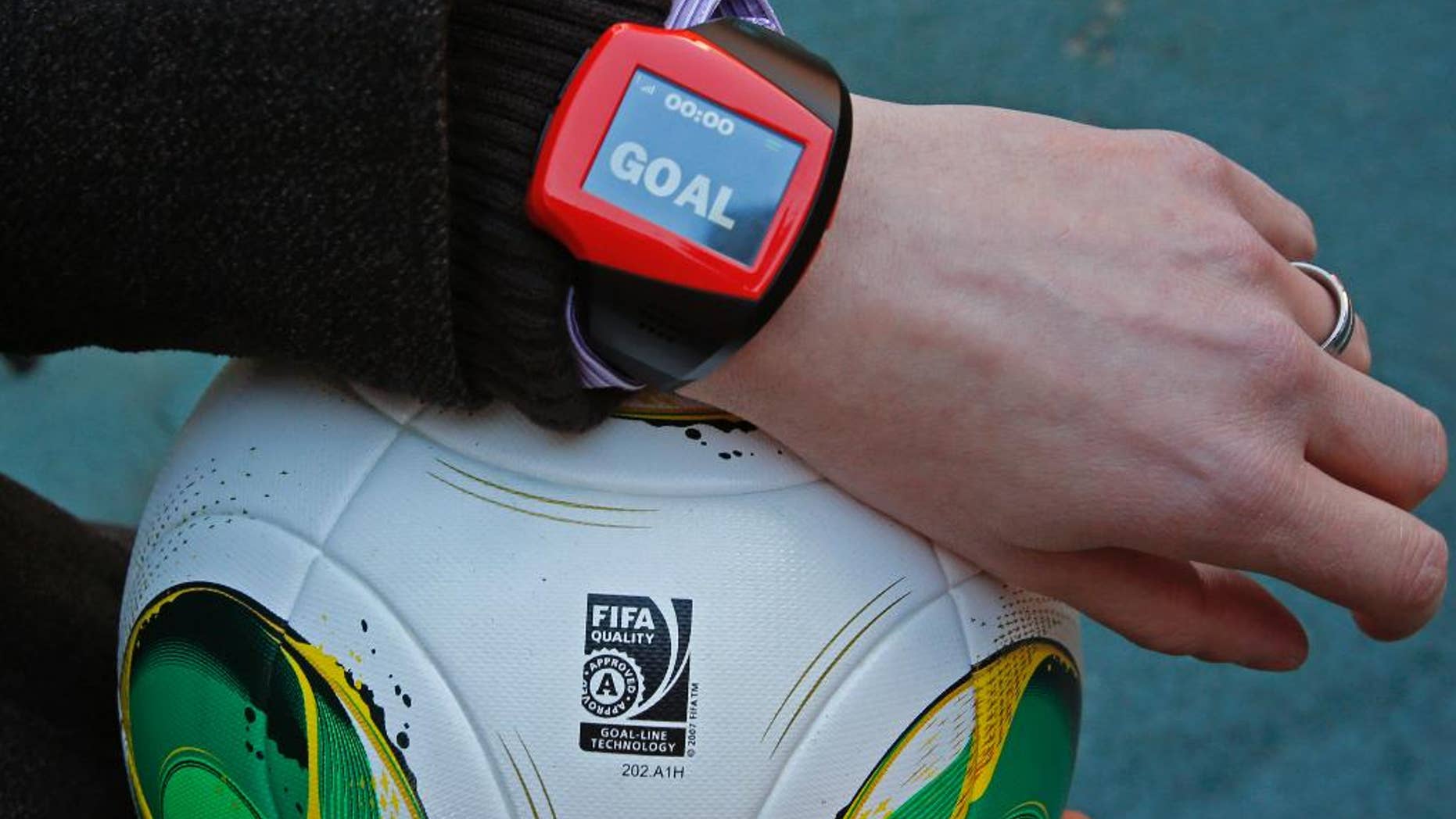 FILE - The Dec. 8, 2012 file photo shows a referee's watch with the goal as they demonstrate the goal-line technology of Hawk-Eye system at Toyota stadium in Toyota. After PSV Eindhoven goalkeeper Jeroen Zoet made the save, he made a costly mistake on Sunday Feb. 26, 2017. Zoet saved a close-range header from Feyenoord defender Jan-Arie van der Heijden, but as he clutched the ball to his chest, a screen on referee Bas Nijhuis' wrist lit up. Nijhuis looked down, saw the word "goal" flashing on the screen and awarded the Dutch league leaders the winning score in a 2-1 victory. (AP Photo/Shuji Kajiyama/File)