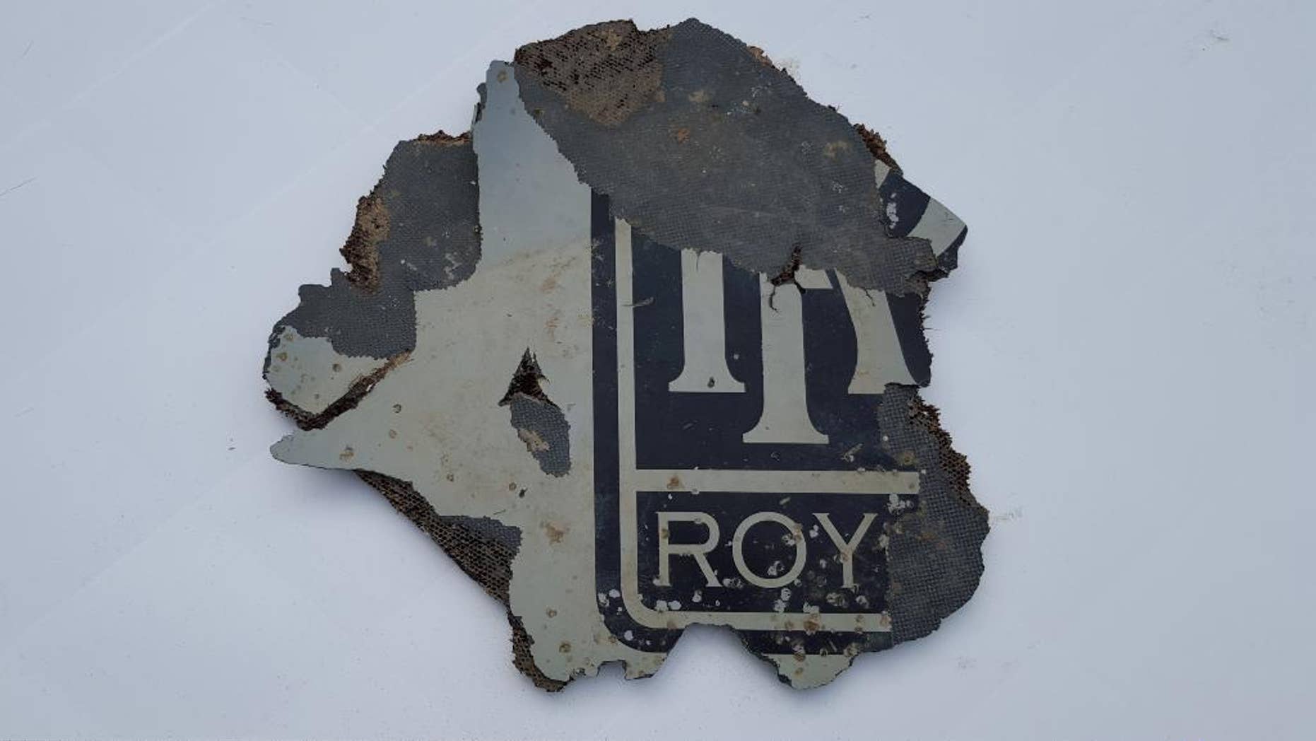 FILE - In this Monday, March 21, 2016, a part of a plane is photographed in Mossel Bay, near Cape Town, South Africa. The part which may be part of a plane engine has been found on the southern coast of South Africa and will be checked to see if it belongs to Malaysia Airlines Flight 370, which vanished two years ago, Malaysian Tranport Minister Liow Tiong Lai said Tuesday, March 22, 2016. (AP Photo/Neels Kruger, File)