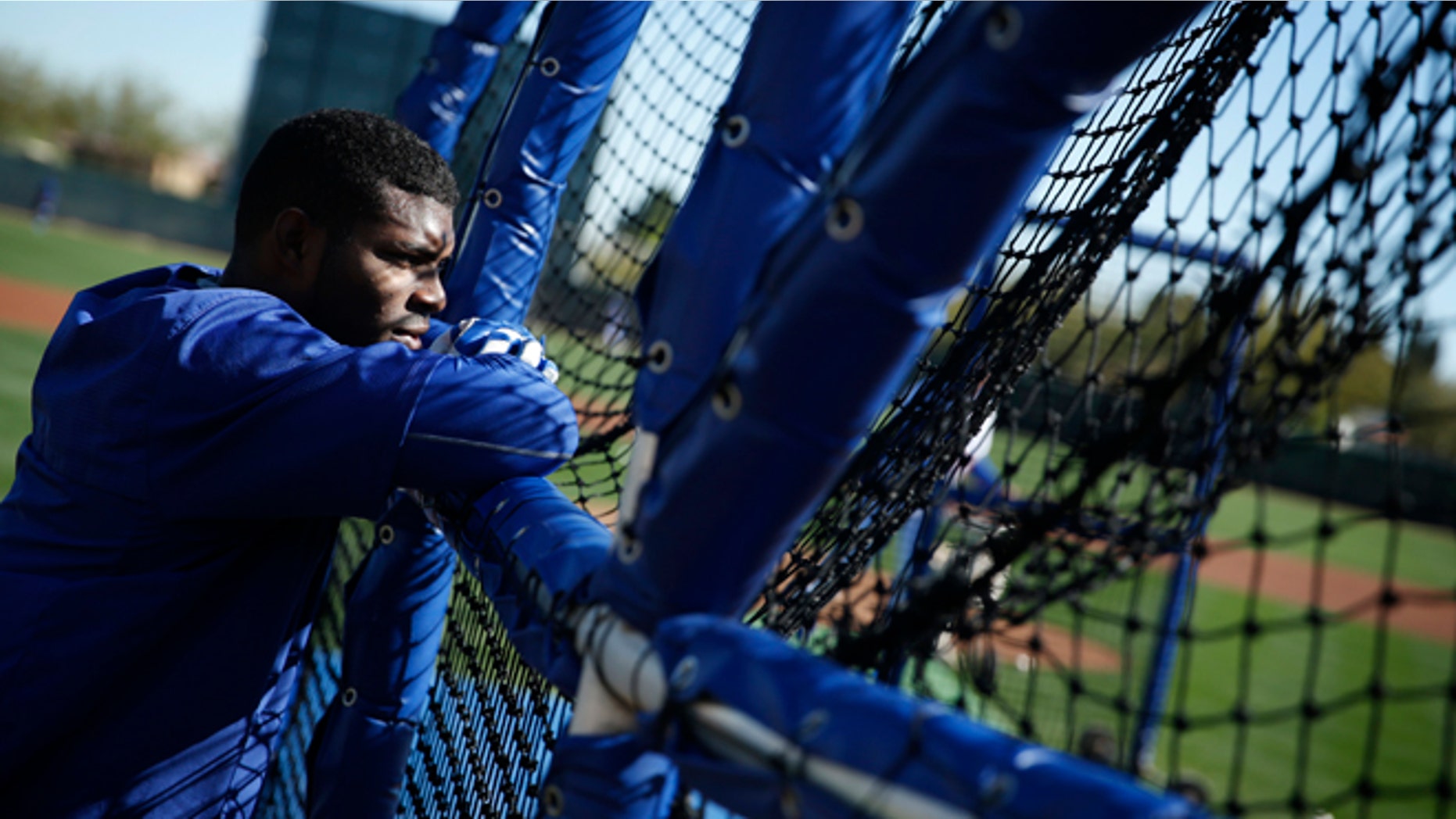 Los Angeles Dodgers' Yasiel Puig watches a batter hit during a spring training baseball workout Wednesday, Feb. 25, 2015, in Phoenix. (AP Photo/John Locher)