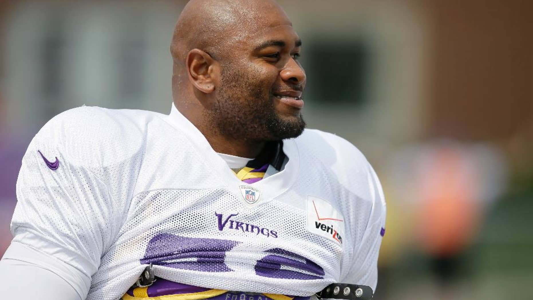 FILE - This July 30, 2014, file photo, shows Minnesota Vikings defensive tackle Tom Johnson walking to the field before an NFL football training camp practice in Mankato, Minn. A police report shows Minneapolis officers used a chemical spray and a stun gun on Vikings' Tom Johnson after he refused to leave a downtown club. Johnson, who is listed at 6-foot-3 and 288 pounds, was arrested early Sunday, Oct. 5, 2014, after security officials and police repeatedly told him to leave Seven steakhouse in Minneapolis. He was charged with misdemeanor counts of trespassing and disorderly conduct. (AP Photo/Charlie Neibergall, File)