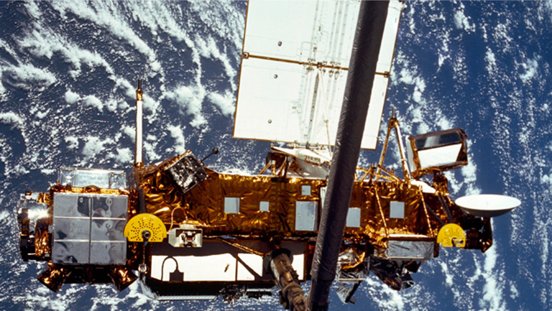 The Upper Atmosphere Research Satellite (UARS) is seen in the grasp of a robotic arm during deployment from the space shuttle in September, 1991. NASA's old research satellite came crashing down through the atmosphere Saturday, Sept. 24, 2011 -- though where exactly may never be known.