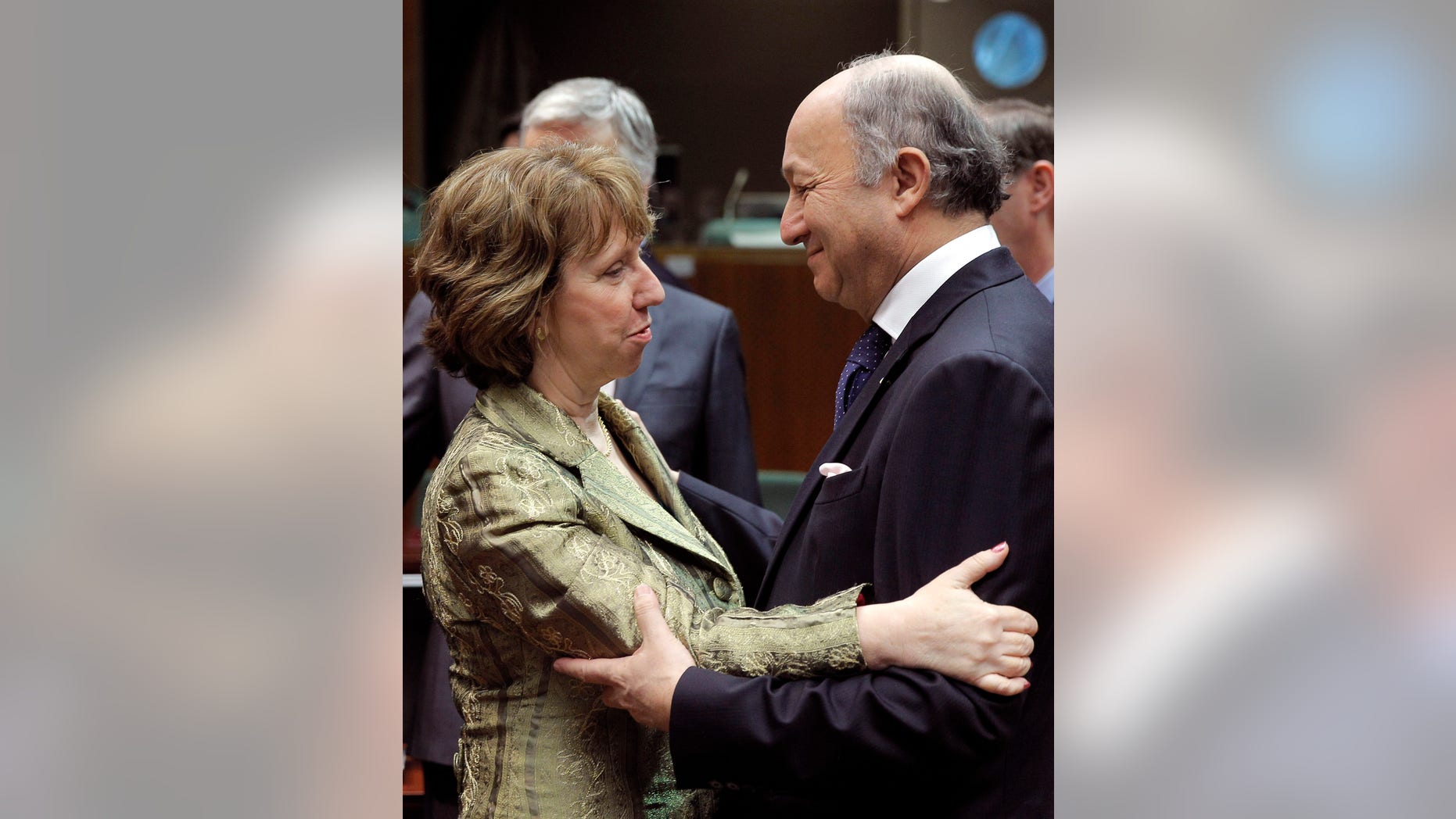 French Foreign Minister Laurent Fabius, right, talks with EU foreign policy chief Catherine Ashton, during the EU foreign ministers meeting, at the European Council building in Brussels, Monday, Dec. 16, 2013. European Union foreign ministers meeting Monday argue that the door remains open for Ukraine to sign an association agreement the EU, even though they criticized the delaying tactics and mixed messages sent by Ukraine President Viktor Yanukovych. (AP Photo/Yves Logghe)