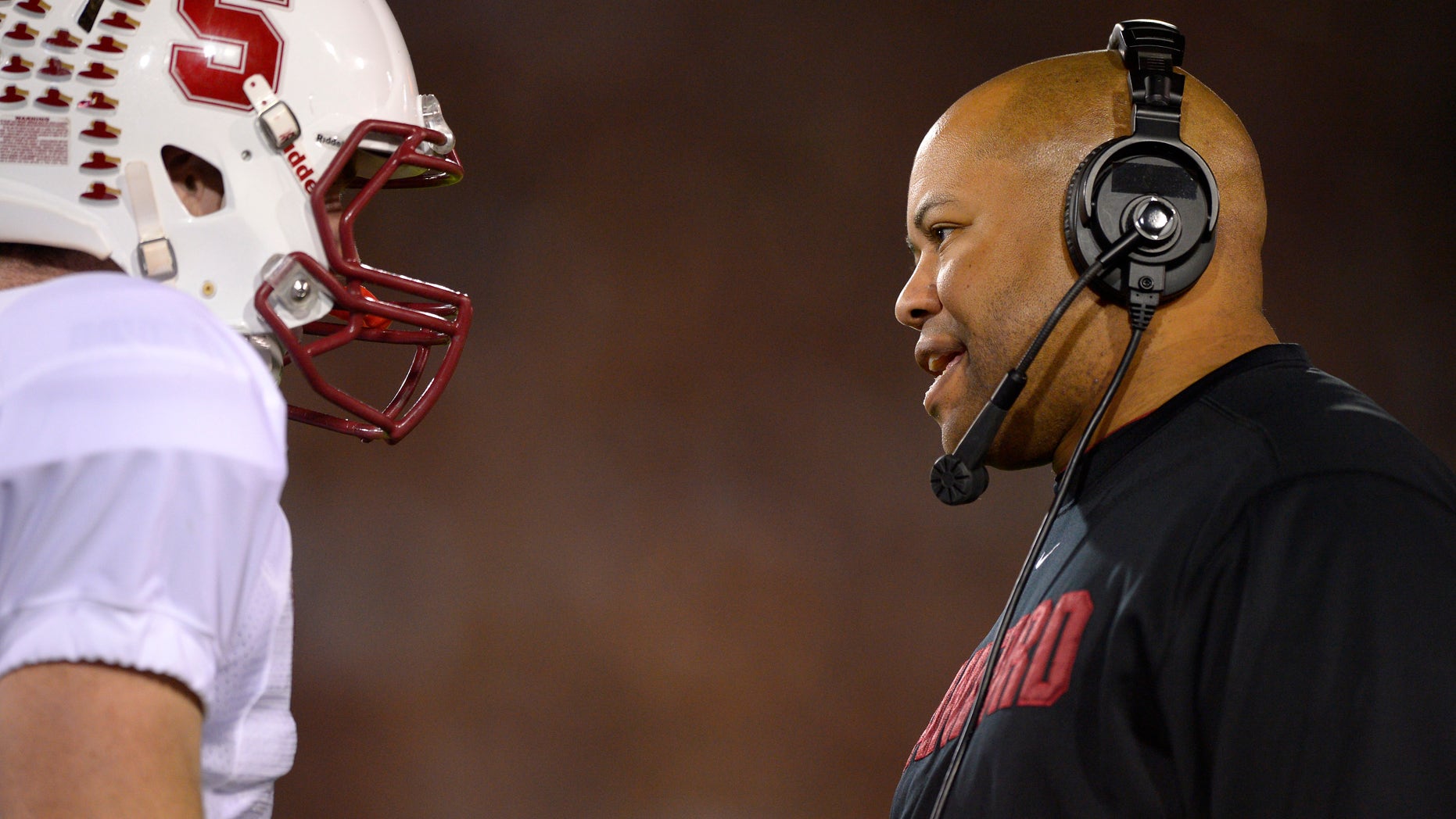 Stanford coach David Shaw, right, talks with quarterback Kevin Hogan during the first half of an NCAA college football game against Southern California, Saturday, Nov. 16, 2013, in Los Angeles. (AP Photo/Mark J. Terrill)