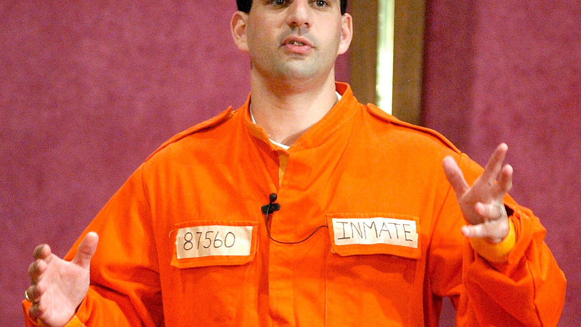 FILE - In this July 7, 2002 file photo, Barry Minkow, a convicted con artist and the co-founder of the for-profit Fraud Discovery Institute, wears a prison jumpsuit costume as he delivers a sermon on materialism at the Community Bible Church in San Diego. Minkow, who went from teenage millionaire to convicted con artist to professional fraud fighter and pastor, was convicted Wednesday, Jan. 22, 2014 of cheating his San Diego church congregation out of some $3 million. (AP Photo/Denis Poroy, File)