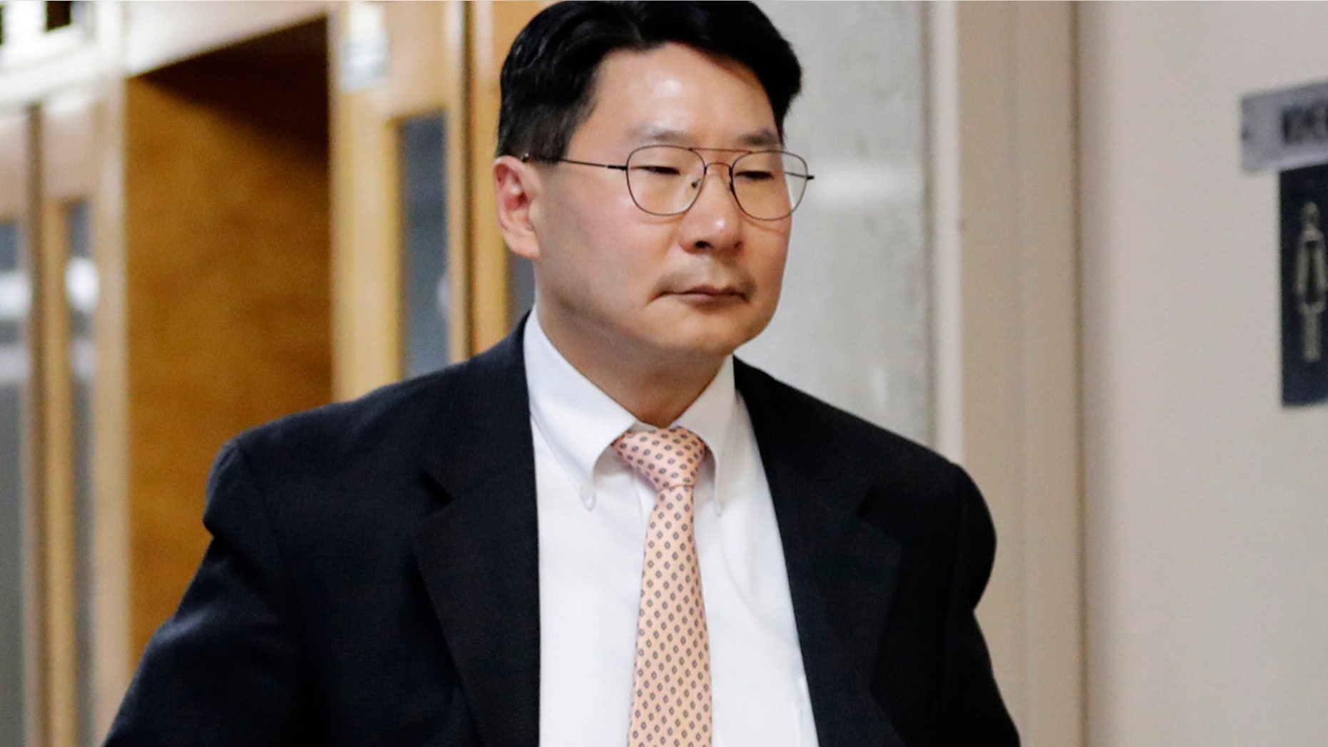 April 27: Dr. Robert Rho walks toward the court room for his trial at Queens County Criminal Court in New York.