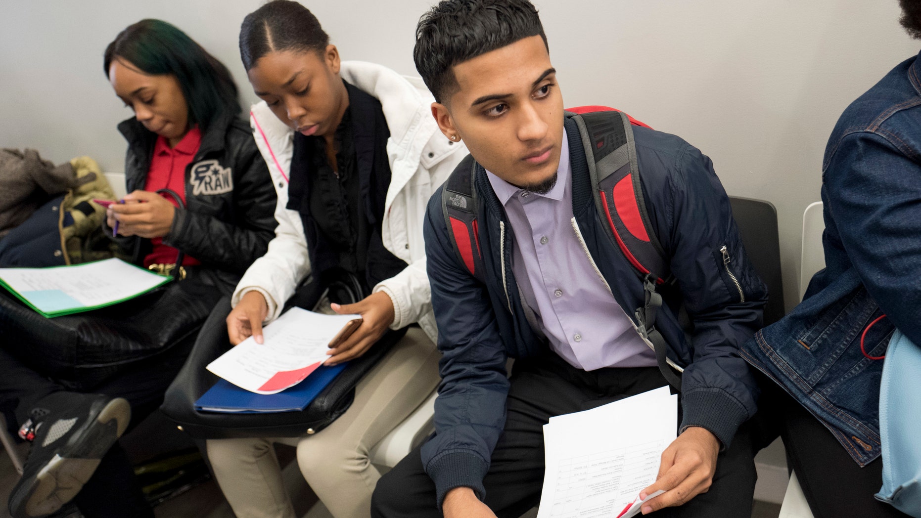 Ammer Gondal, who is looking for work in the retail or food industry, waits to see a recruiter in New York.