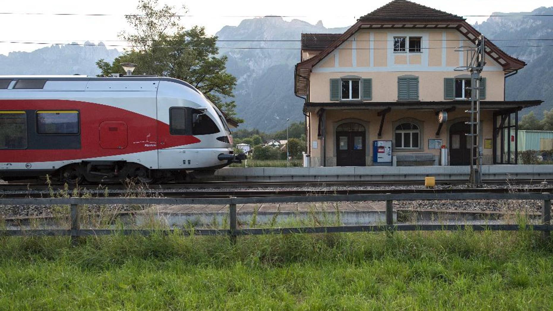 The train station Salez - Sennwald photographed in Salez, Switzerland, on Sunday Aug. 14, 2016. The man who attacked passengers on a crowded Swiss train with a knife and burning liquid died of his wounds Sunday, as did one of his victims, a 34-year-old woman, Swiss police said. Three others remain hospitalized with serious wounds. Police are still searching for a motive but said there's no indication the suspect, identified only as a 27-year-old Swiss man from a neighboring region, had ties to extremist groups. (Gian Ehrenzeller/Keystone via AP)