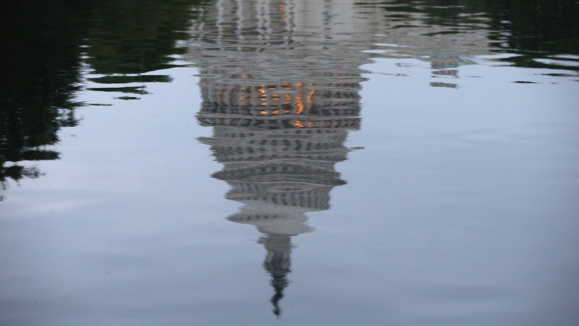 WASHINGTON, DC - JUNE 11: The U.S. Capitol is reflected in water on the morning of June 11, 2014 in Washington, DC. Yesterday House Majority Leader Eric Cantor (R-VA) lost his Virginia primary to Tea Party challenger Dave Brat. (Photo by Mark Wilson/Getty Images)