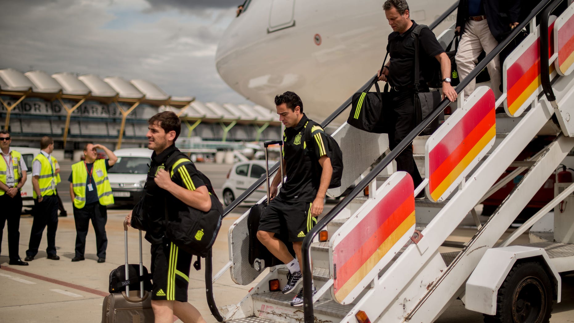 Iker Casillas (L) and Xavi Hernandez of Spain arrive at Barajas-Adolfo Suarez Airport on June 24, 2014 in Madrid, Spain.