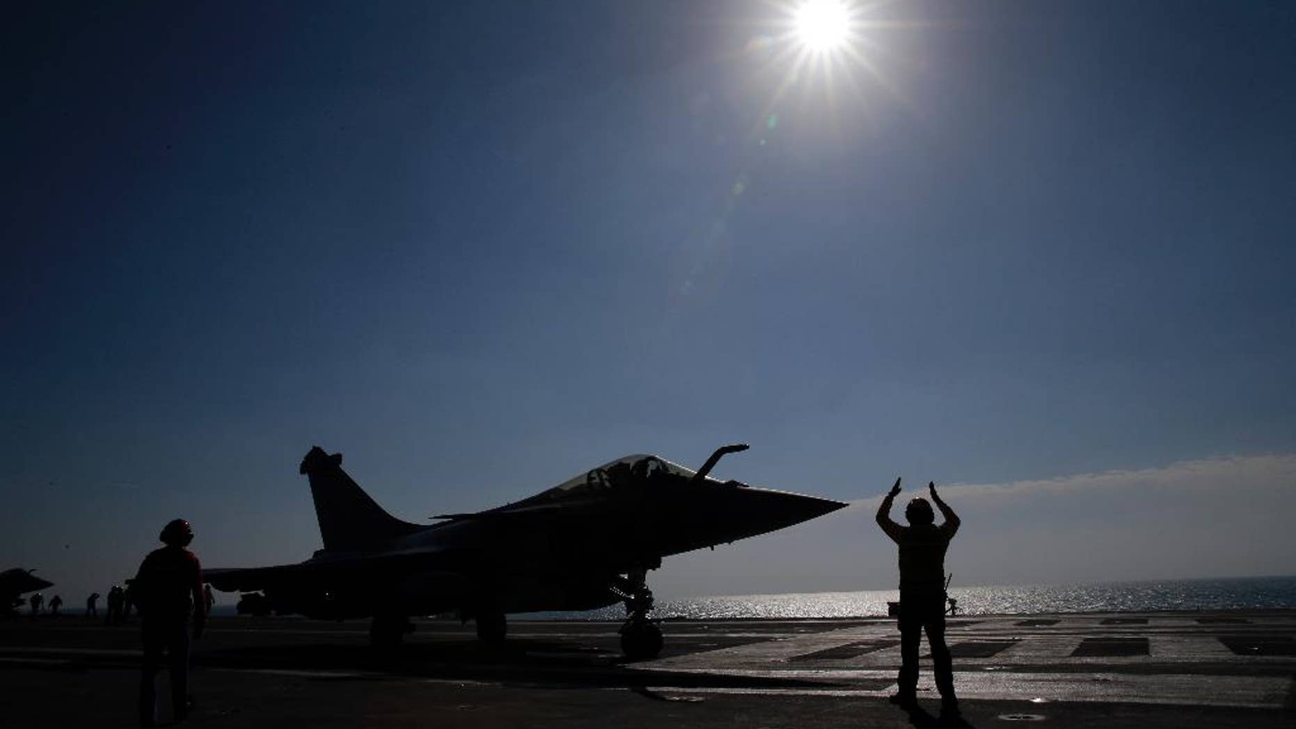 FILE - In this Jan.12, 2016 file photo, a Rafale jet fighter is catapulted on France's flagship Charles de Gaulle aircraft carrier in the Persian Gulf. French warplanes are flying over Iraq Friday Sept. 30, 2016 after France's Charles de Gaulle aircraft carrier rejoined the U.S.-led fight against Islamic State extremists and the coalition prepares to try to take back the city of Mosul. (AP Photo/Christophe Ena, File)
