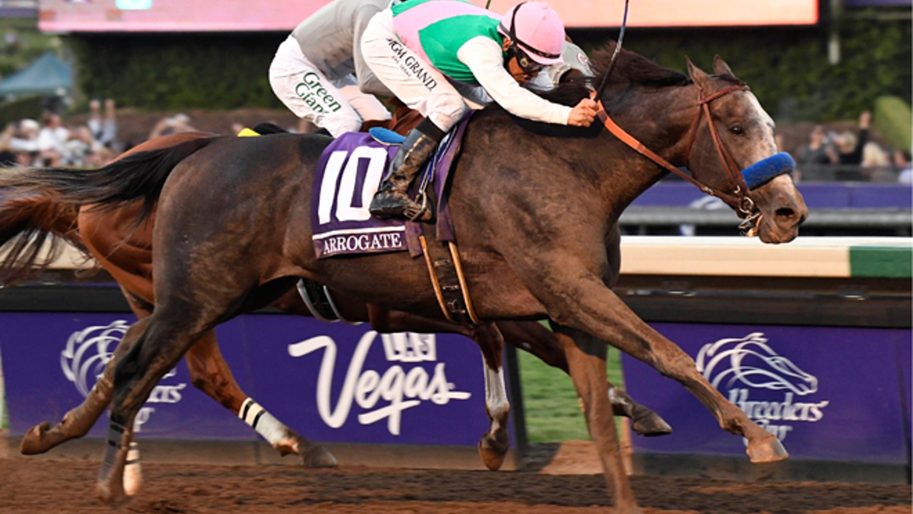 Nov 5, 2016; Santa Anita, CA, USA; Mike Smith aboard Arrogate takes the lead in front of Victor Espinoza aboard California Chrome in race twelve during the 33rd Breeders Cup world championships at Santa Anita Park