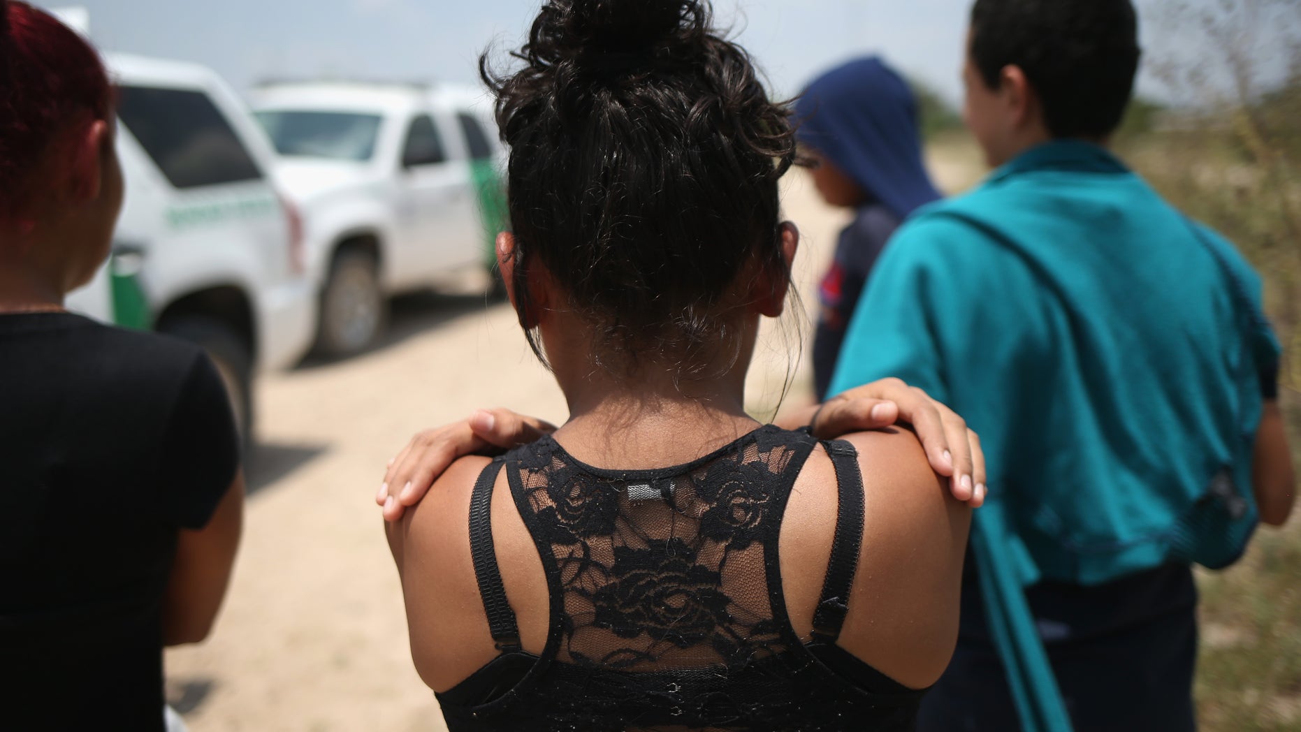 MISSION, TX - JULY 24: Unaccompanied minors from El Salvador await transport to a U.S. Border Patrol processing center after they crossed the Rio Grande from Mexico into the United States on July 24, 2014 in Mission, Texas. Tens of thousands of undocumented immigrants, many of them unaccompanied minors, have crossed illegally into the United States this year and presented themselves to federal agents, causing a humanitarian crisis on the U.S.-Mexico border. (Photo by John Moore/Getty Images)