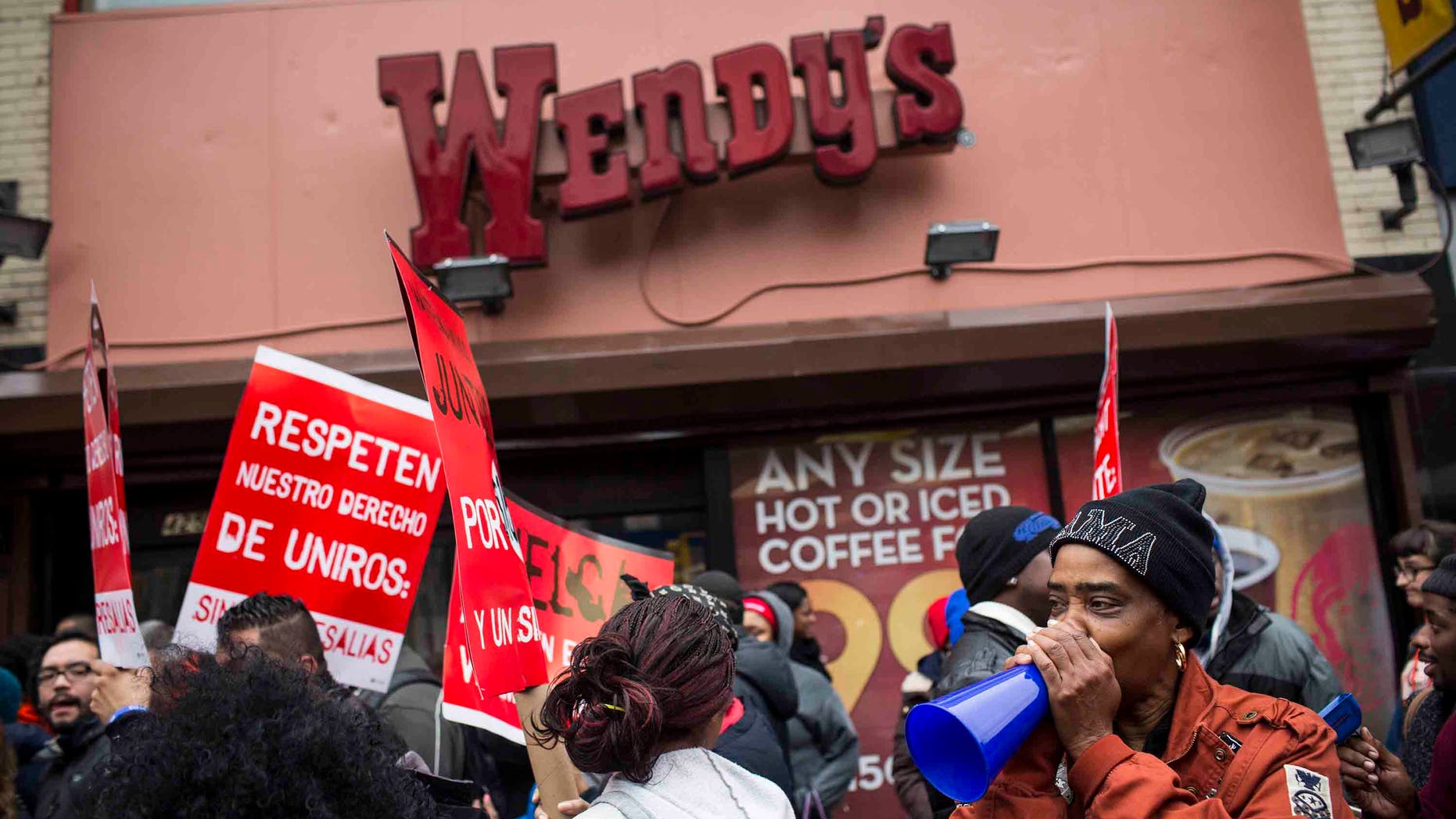 NEW YORK, NY - DECEMBER 05: Protesters rally outside of a Wendy's in support of raising fast food wages from $7.25 per hour to $15.00 per hour on December 5, 2013 in the Brooklyn borough of New York City. A growing number of fast food workers in the United States have been staging protests outside restaurants, calling for a raise in wages, claiming it is impossible to live resonably while earning minimum wage. (Photo by Andrew Burton/Getty Images)