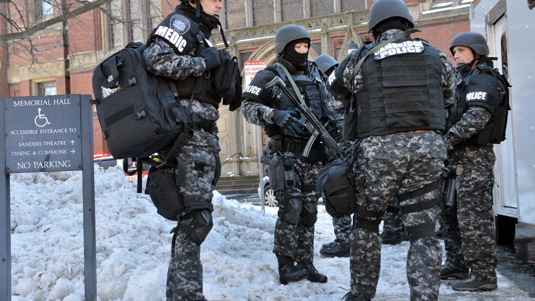 Tactical police assemble outside a building at Harvard University in Cambridge, Mass., Monday, Dec. 16, 2013. Four buildings on campus were evacuated after campus police received an unconfirmed report that explosives may have been placed inside, interrupting final exams. (AP Photo/Josh Reynolds)