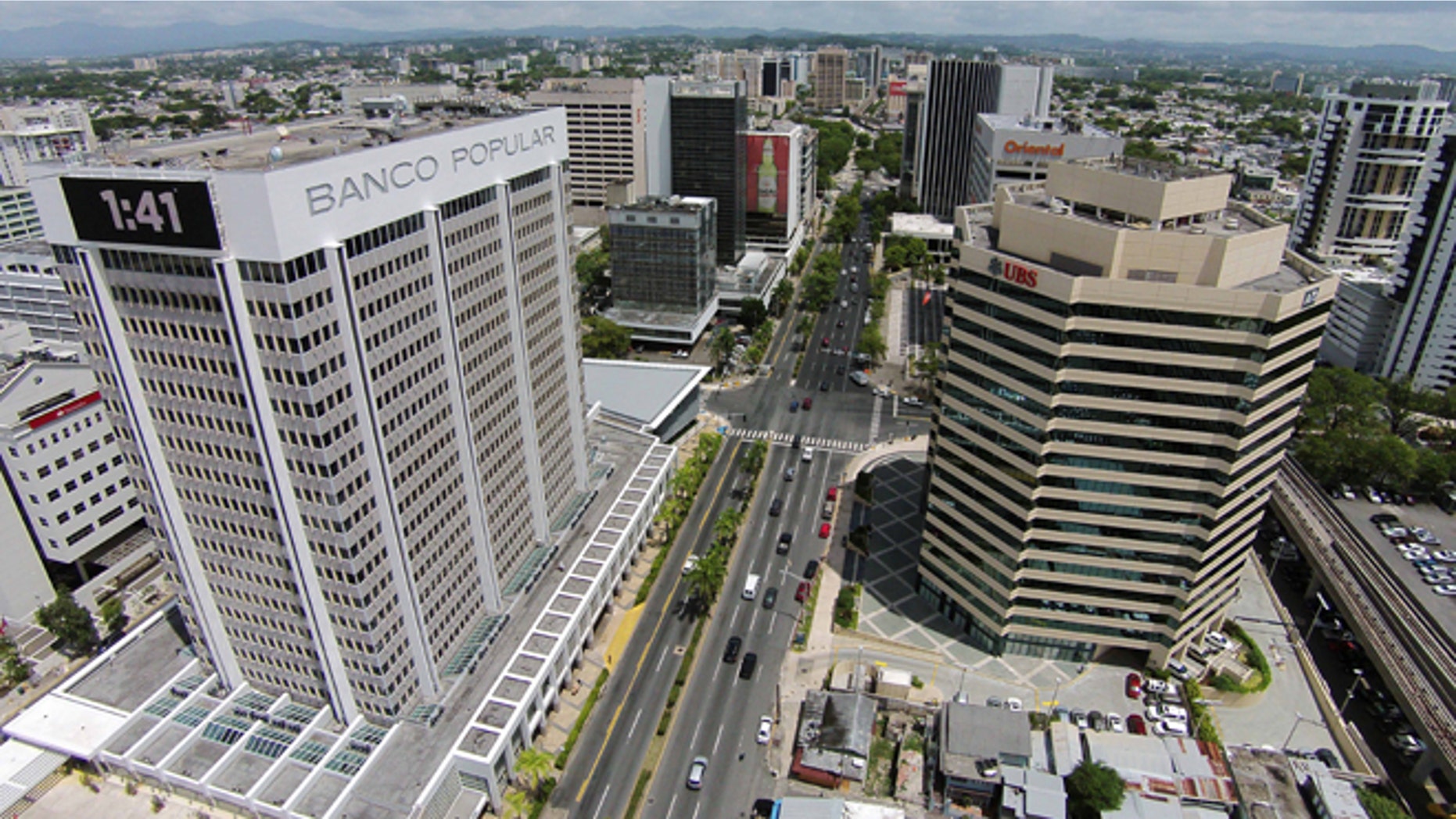 This July 16, 2014, phoro shows an aerial view of the financial district in San Juan, Puerto Rico. The territorys government has managed to buy some time to stave off an economic crisis, but it may only be for a moment. Creditors are closely watching whether the government tries to reach substantial agreements with banks this month on how to handle upcoming payments. (AP Photo/Ricardo Arduengo)