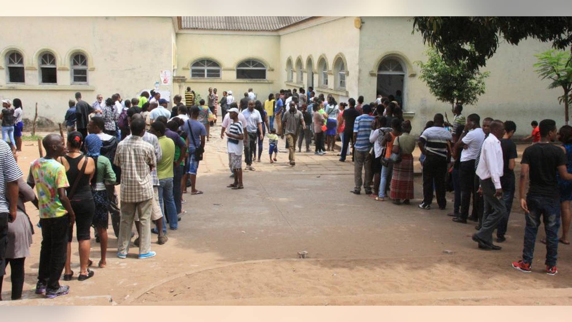 File: In this Wednesday, Oct. 15, 2014 file photo voters queue to cast their votes at a polling station, in Maputo, Mozambique. The country's national elections commission said Monday, Oct. 20, 2014 that vote counting in the northwestern province was stopped due to possible fraud with more than 60 percent of votes coounted so far. (AP Photo/Ferhat Momade, File)