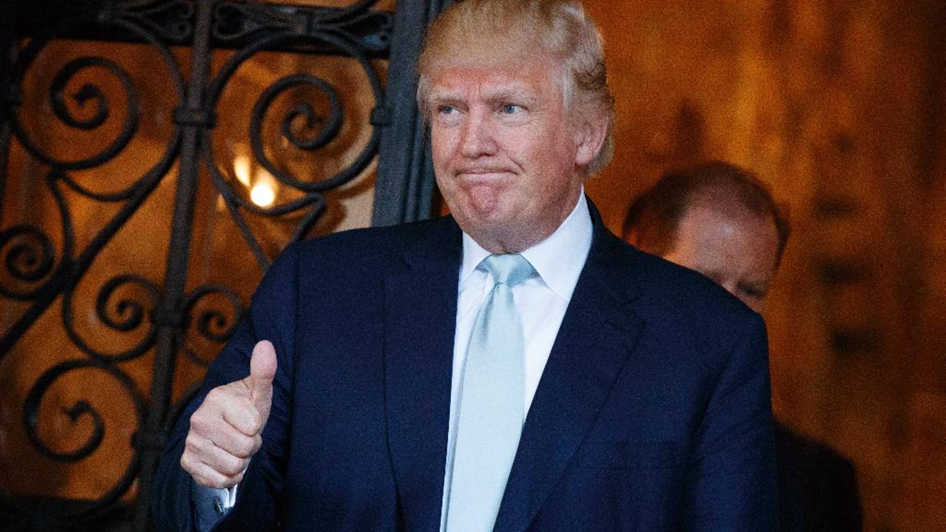 President-elect Donald Trump gives a thumbs up to reporters at Mar-a-Lago, Wednesday, Dec. 28, 2016, in Palm Beach, Fla. (AP Photo/Evan Vucci)