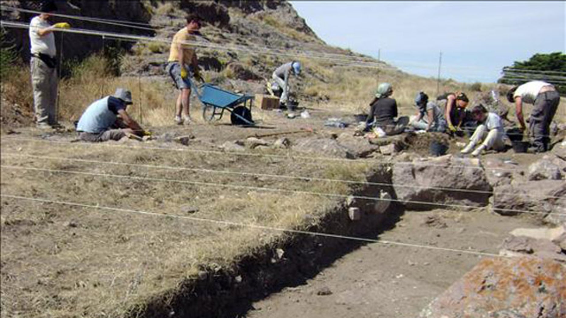 Argentine anthropologists search a lakeside beach, where they found human skeletal remains some 8,270 years old.