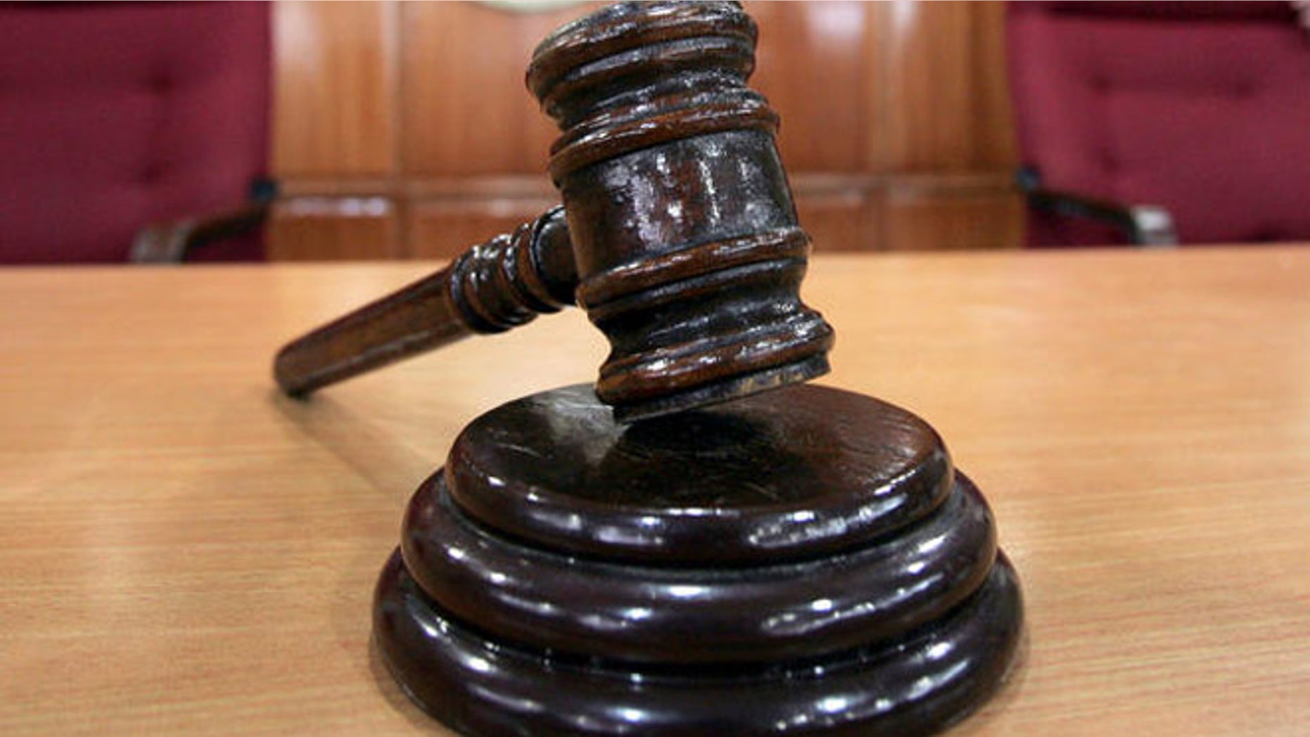 A Sandiganbayan anti-graft court sheriff adjusts chairs inside a courtroom in Quezon city northeast of Manila, Philippines, Tuesday Sept. 11, 2007, where a verdict in ousted Philippine President Joseph Estrada's corruption trial will be announced on Wednesday. (AP Photo/Bullit Marquez)