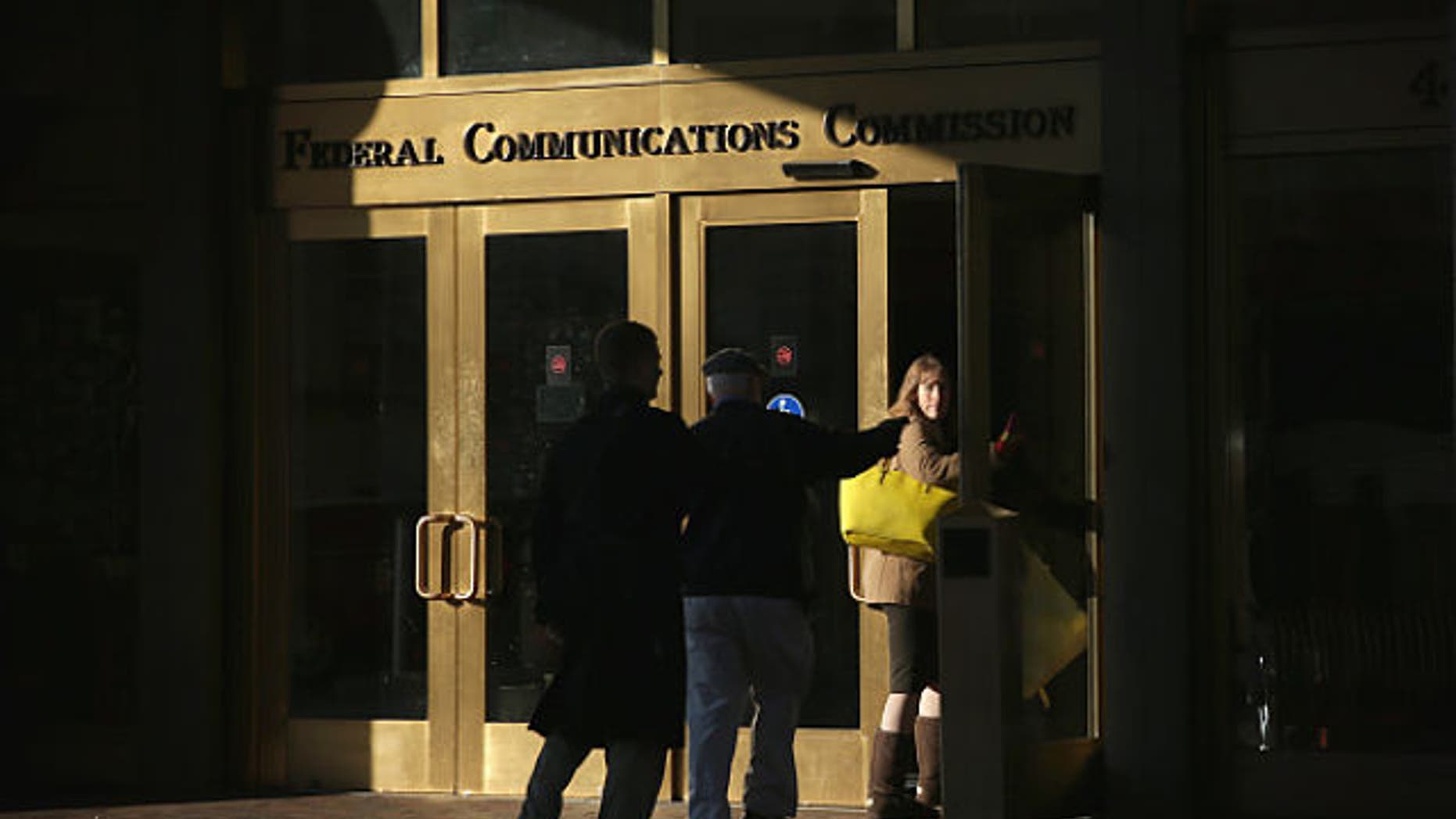 WASHINGTON, DC - DECEMBER 11: People enter the building of Federal Communications Commission December 11, 2014 in Washington, DC. The commission held its monthly meeting as activists held a rally outside to call for net neutrality. (Photo by Alex Wong/Getty Images)