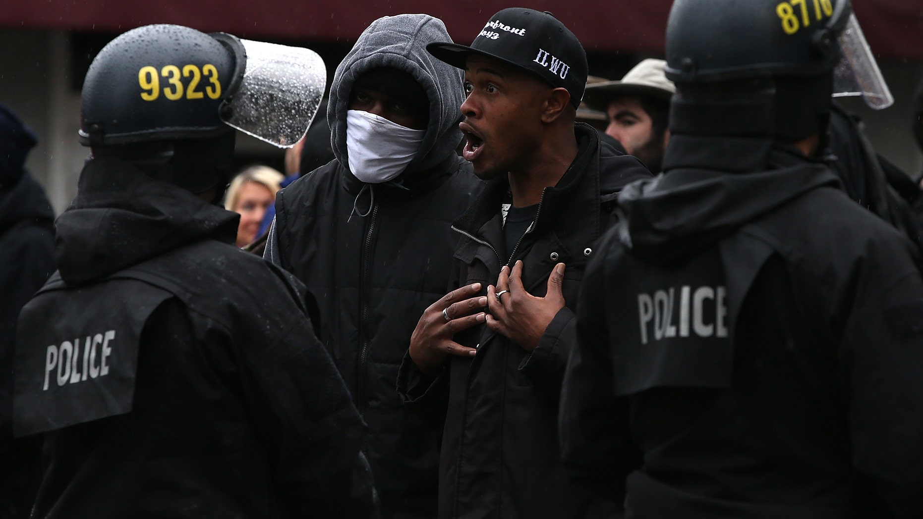 OAKLAND, CA - DECEMBER 15: A protestor yells at a line of Oakland police officers during a demonstration over recent grand jury decisions in police-involved deaths on December 15, 2014 in Oakland, California. Over 200 hundred protestors blocked entrances to the Oakland police department and adjacent streets during a demonstration against recent grand jury decisions in New York and Missouri to not charge white police officers with the deaths of black men. Dozens were arrested. (Photo by Justin Sullivan/Getty Images)