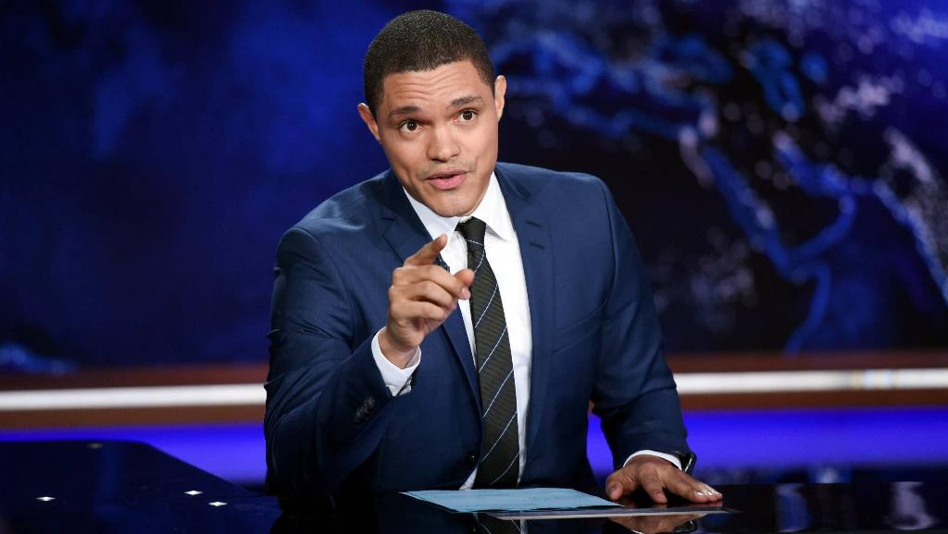 FILE - In this Sept. 29, 2015, file photo, Trevor Noah works on set during a taping of "The Daily Show with Trevor Noah" in New York. As they returned to work after Sunday morning's mass shooting in a gay nightclub in Orlando, Fla.,, TV's late-night hosts faced the challenge none of them looks forward to. They had to find a way to bond with their viewers, as they do every night, but with shared feelings unrelieved by the comfort of comedy. That is what Noah did Monday, June 13, 2016. (Photo by Evan Agostini/Invision/AP, File)