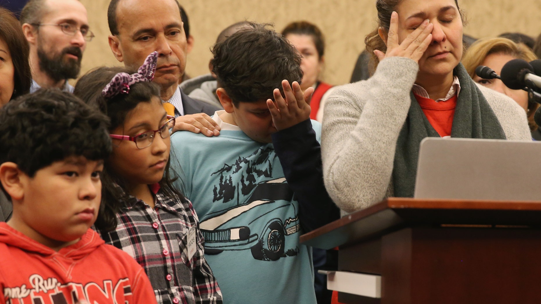 WASHINGTON, DC - JANUARY 14: Isabel Aguilar (R) speaks about immigration while flanked by her children Adolfo Martinez 13 (C), Miranda Aguilar 8 (2ndL), and Emillio Aguilar 7 (L), during a news conference on Capitol Hill, January 14, 2015 in Washington, DC. Ms. Aguilar joined House Democrats to urge members of Congress not to pass legislation to fund the Department of Homeland Security with attached anti-immigrant amendments. (Photo by Mark Wilson/Getty Images)