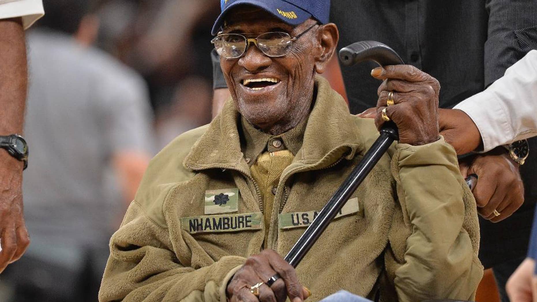 FILE - In this March 23, 2017, file photo, Richard Overton leaves the court after a special presentation honoring him as the oldest living American war veteran, during a timeout in an NBA basketball game between the Memphis Grizzlies and the San Antonio Spurs. Overton was honored by his hometown of Austin, Texas, on his 111th birthday on May 11, 2017. (AP Photo/Darren Abate, File)